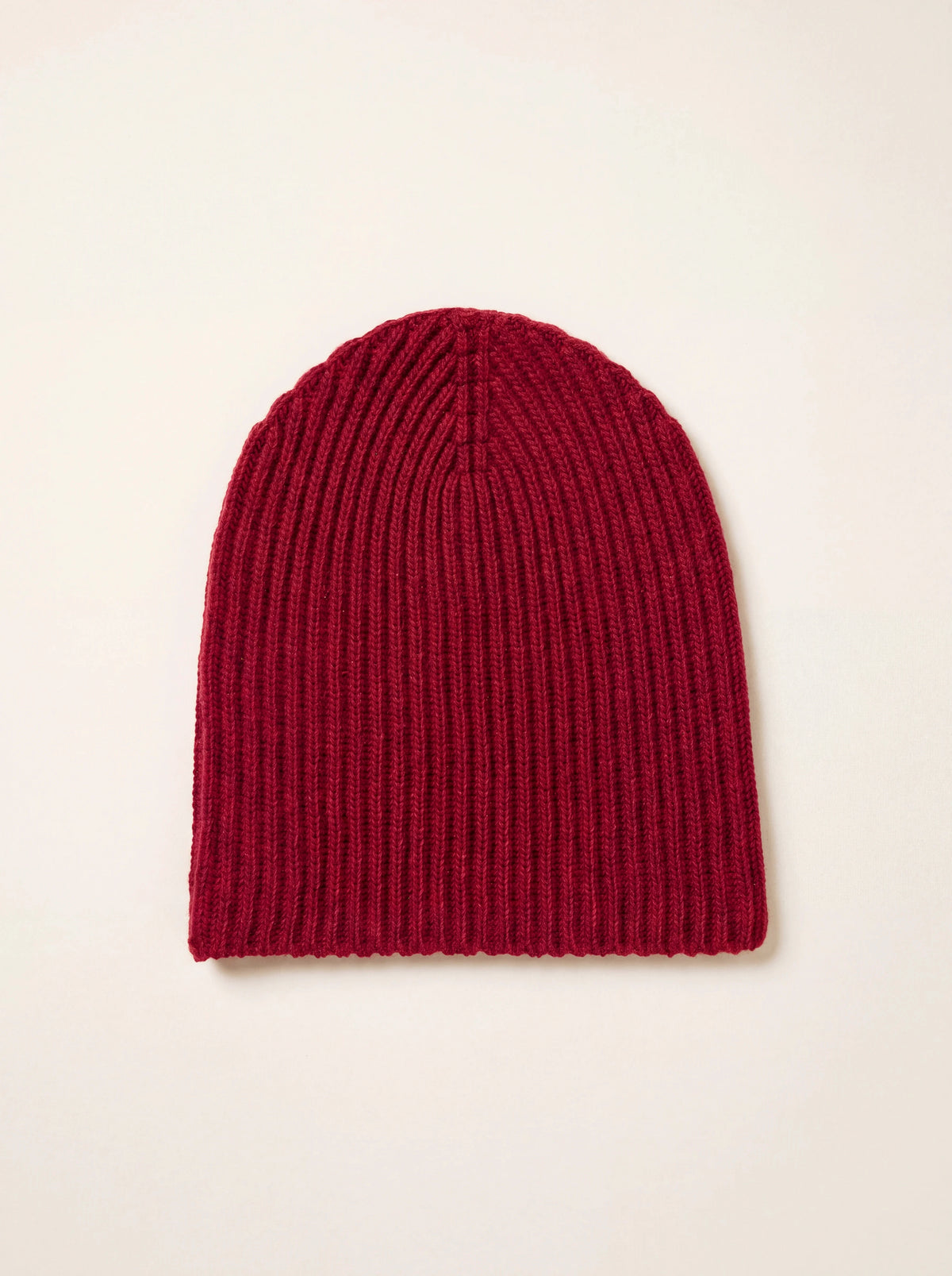 Ribbed claret cashmere beanie with a rounded crown, laid flat