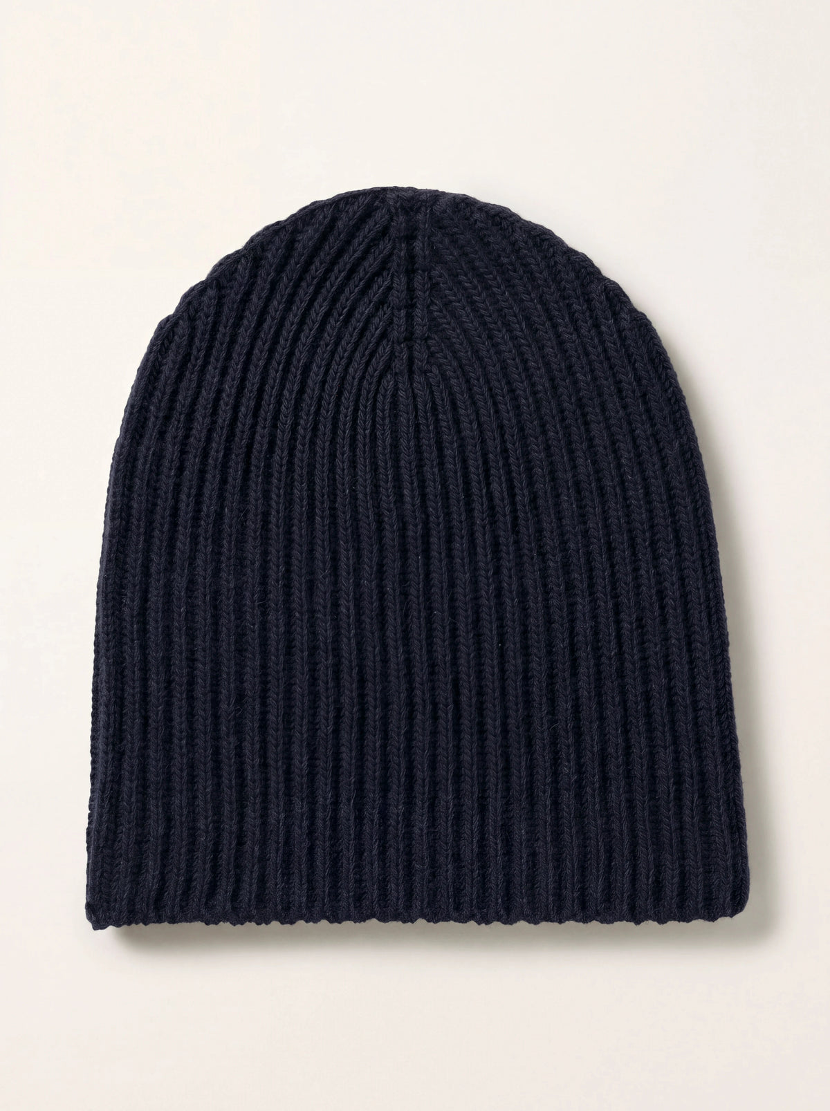 Dark navy ribbed cashmere beanie laid flat with a tapered crown