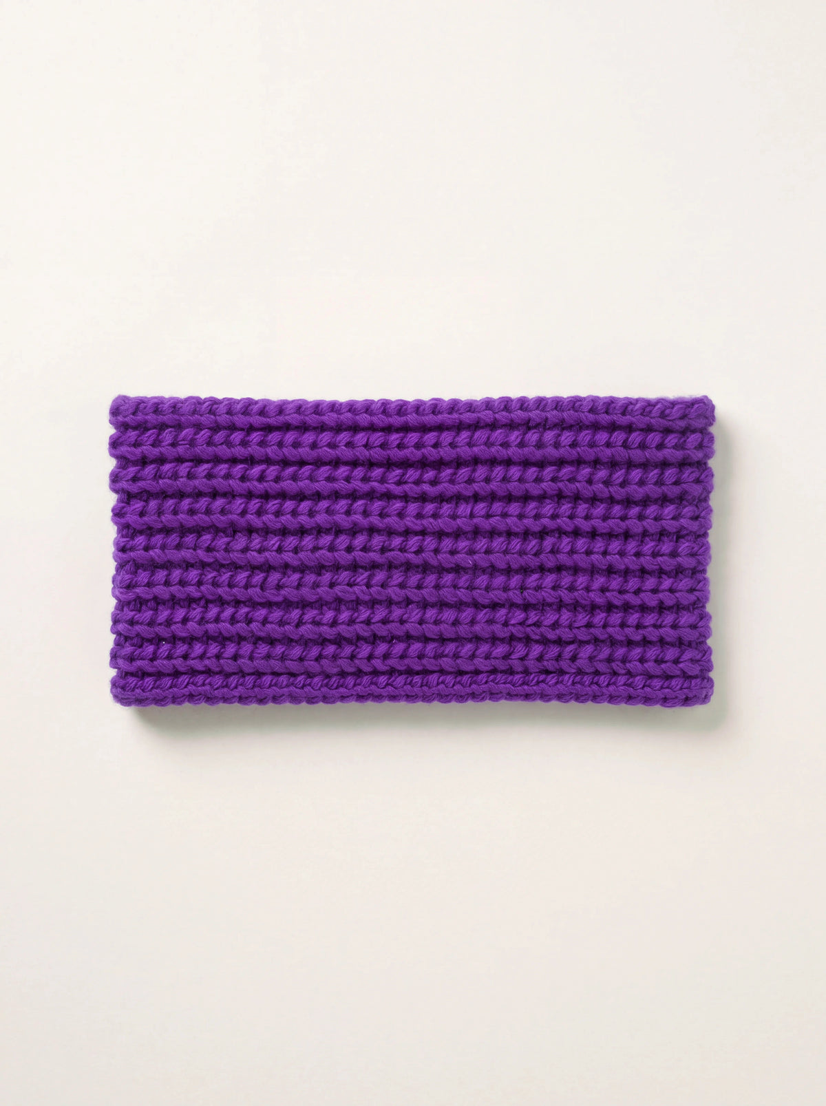Violet cashmere headband in a horizontal rib knit, laid flat