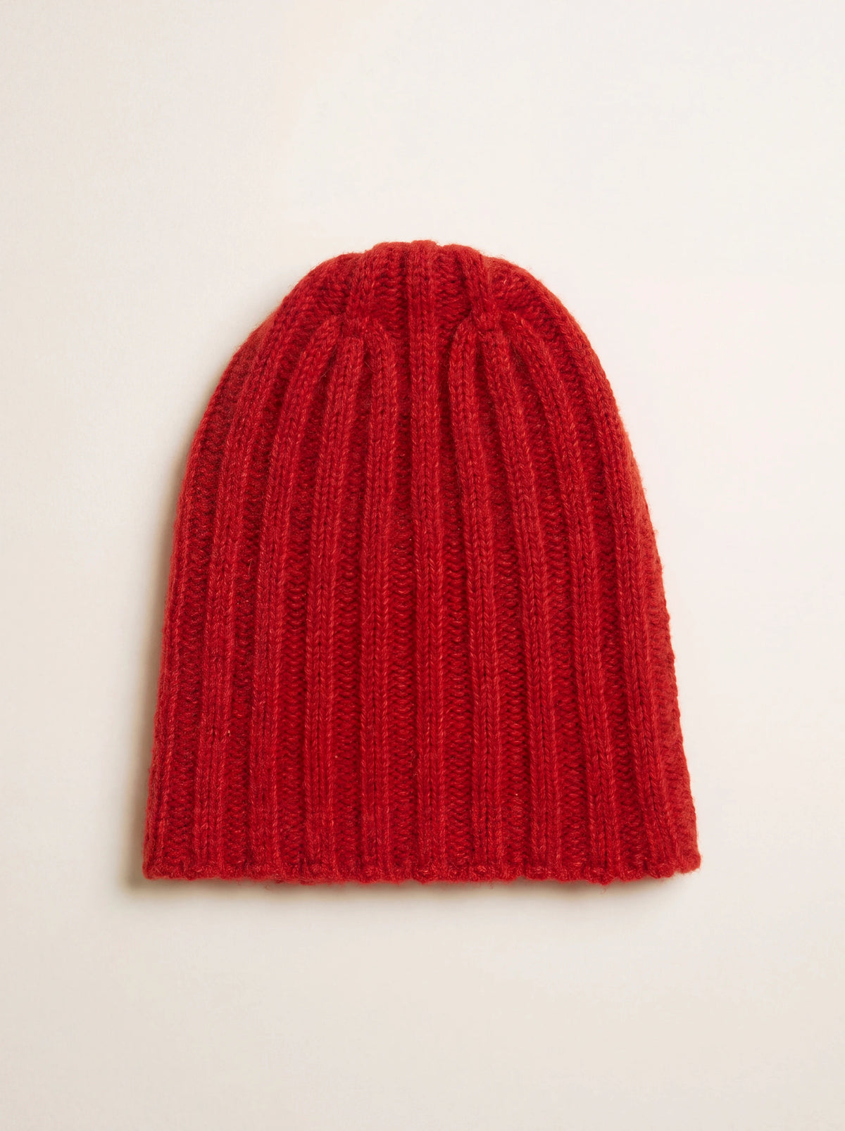 Red ribbed cashmere and silk beanie shown flat and unfolded with a brushed finish