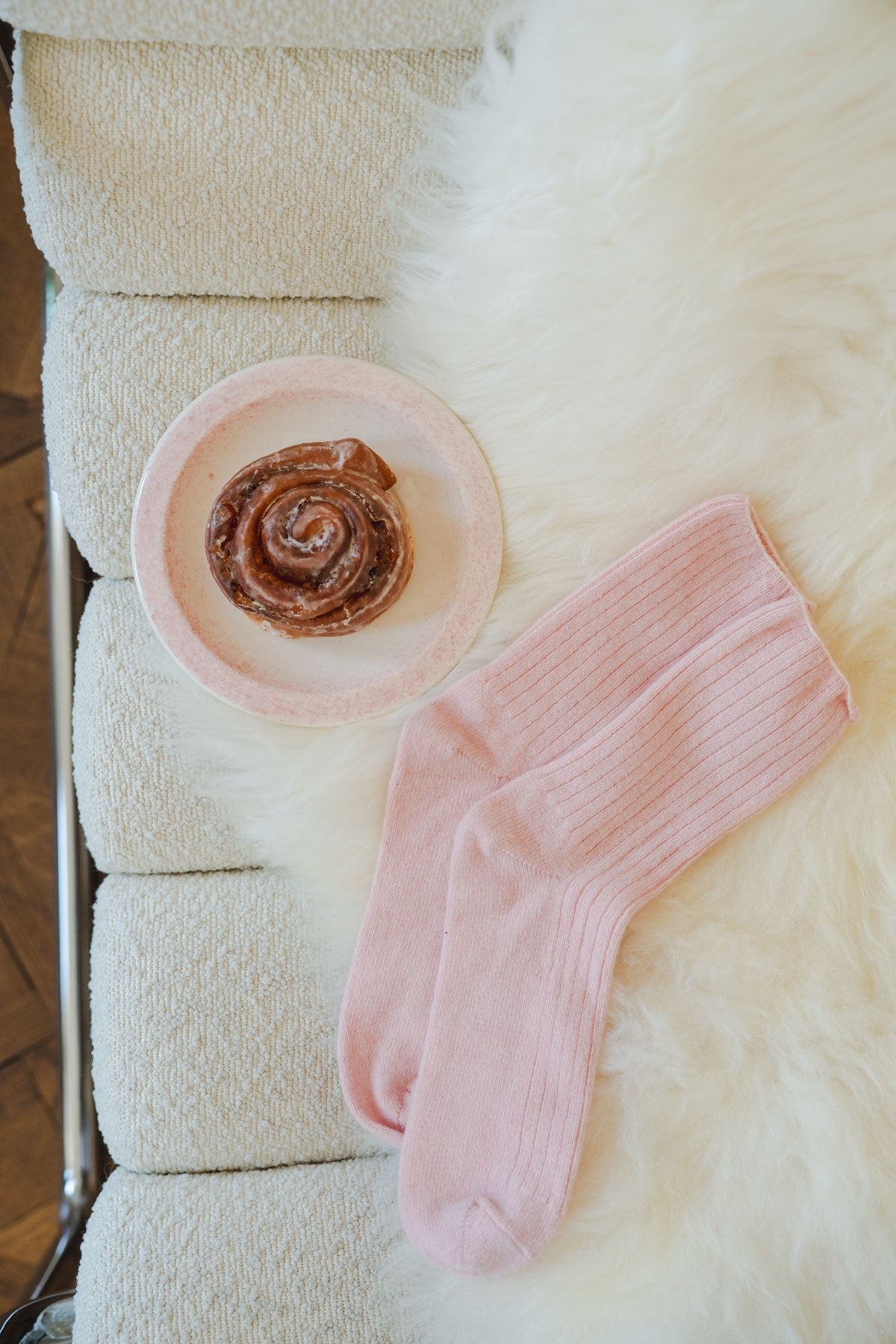 Light pink ribbed socks made from a merino wool and cashmere blend, laid flat