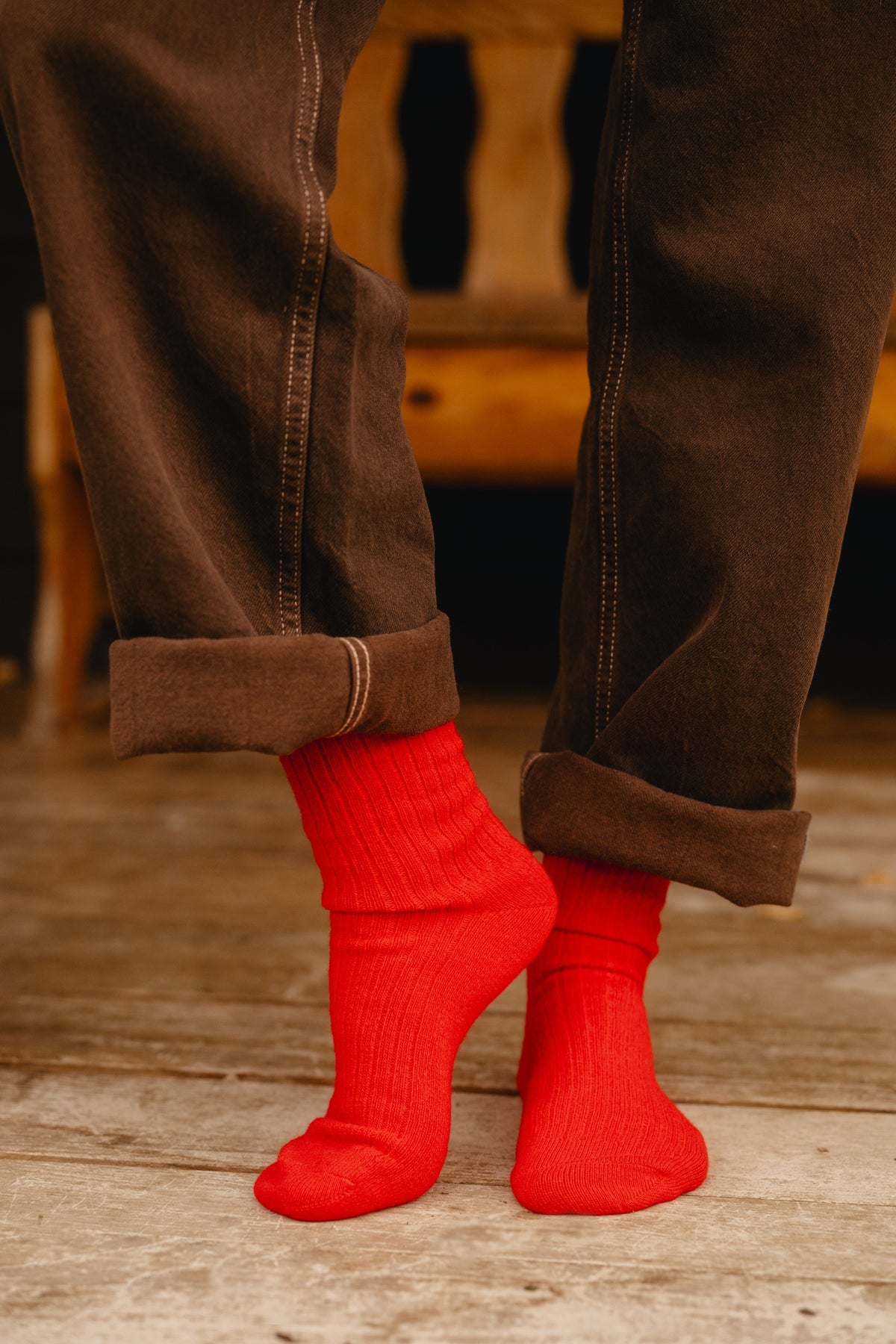Red ribbed wool and cashmere blend socks worn on feet with turned-up trousers