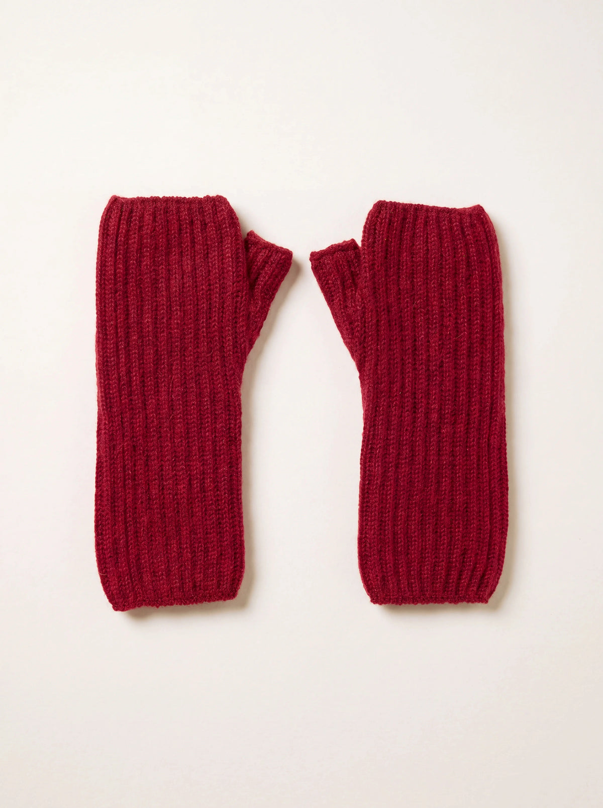 Claret cashmere ribbed wrist warmers laid flat, showing thumb openings and open-finger design