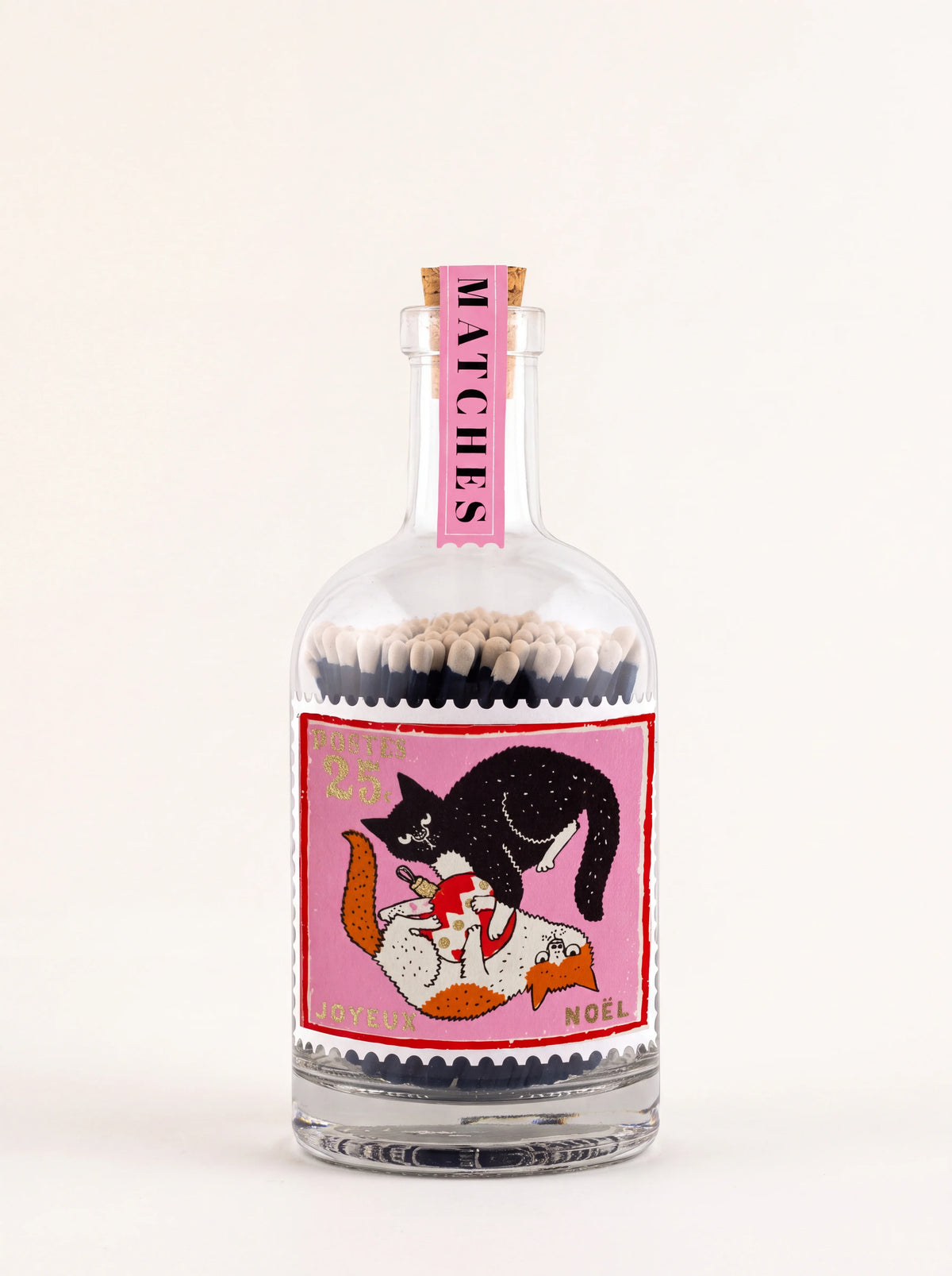 Clear glass match bottle with cork stopper and stamp label showing two cats playing with a Christmas bauble
