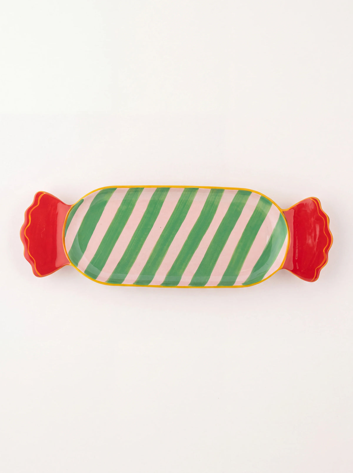 Stoneware serving plate shaped like a wrapped sweet with pink and green stripes and red ends