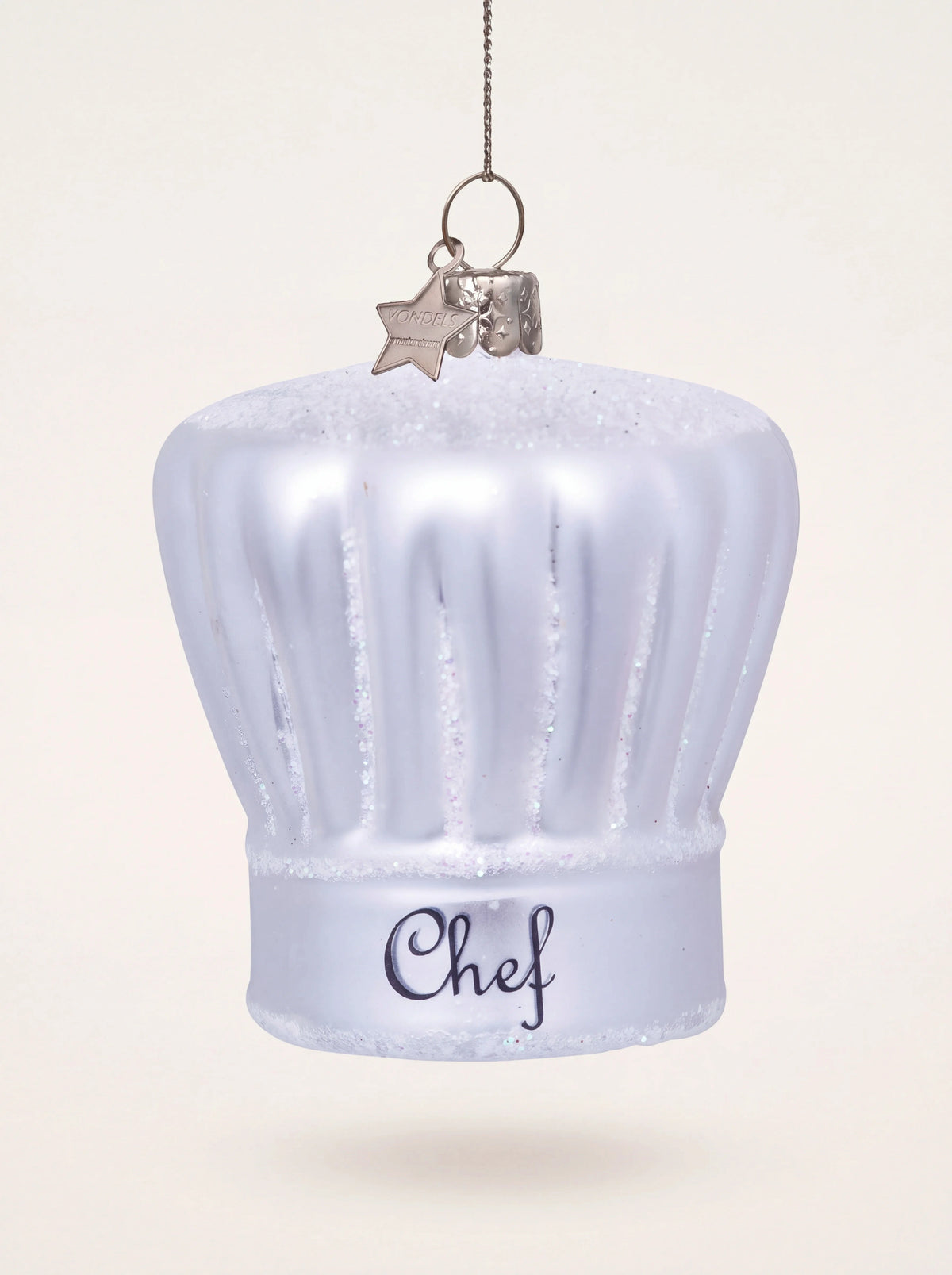 White glass chef's hat Christmas ornament with silver glitter accents and script lettering Chef on the band