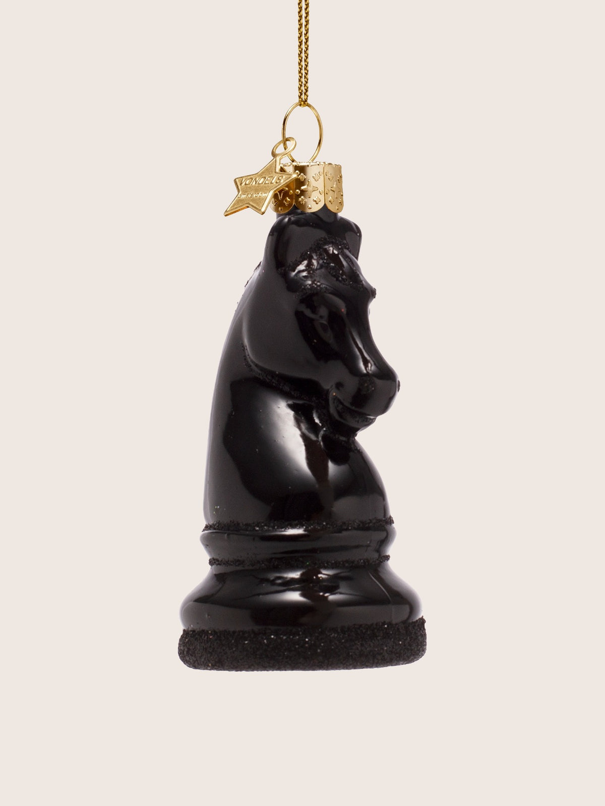 Three-quarter view of the chess knight ornament, showing the sculpted head and base