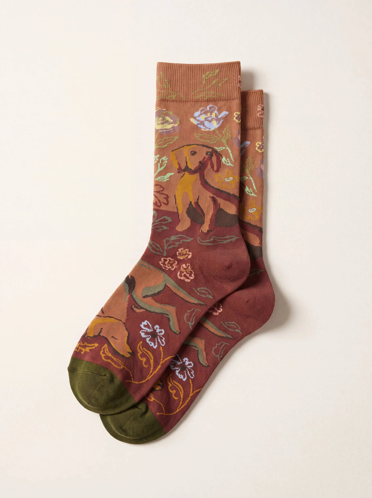 Caramel brown cotton socks patterned with dogs and flowers, featuring ribbed cuffs and green toes