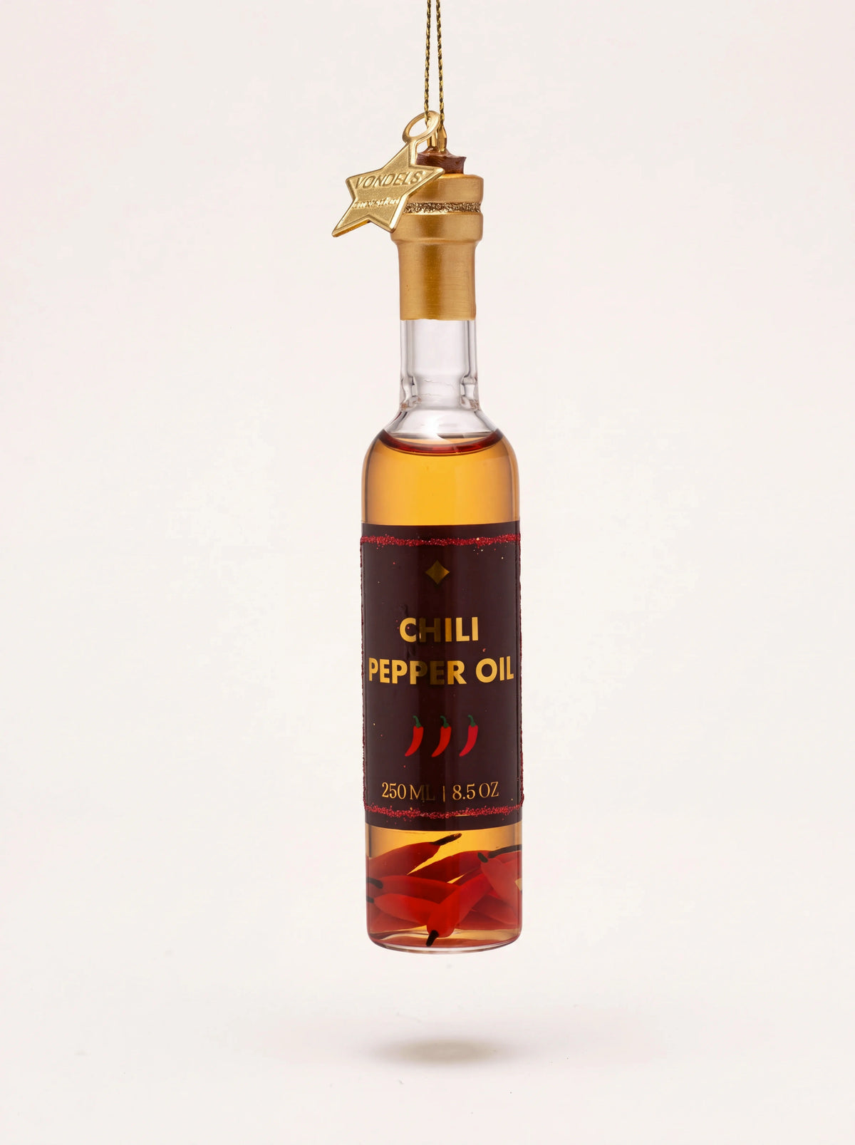 Glass chili pepper oil bottle ornament with a gold-coloured neck and label reading Chili Pepper Oil