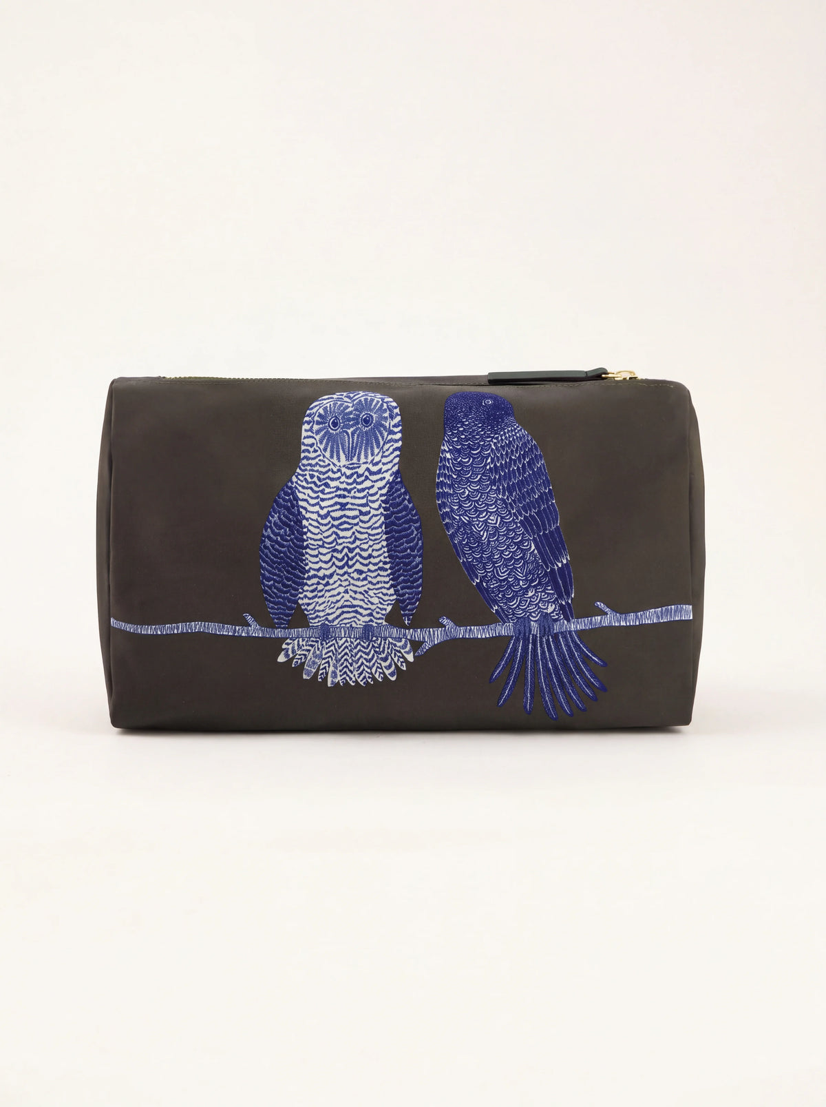 Khaki wash bag featuring a blue and white owl and bird perched on a branch, with top zip closure