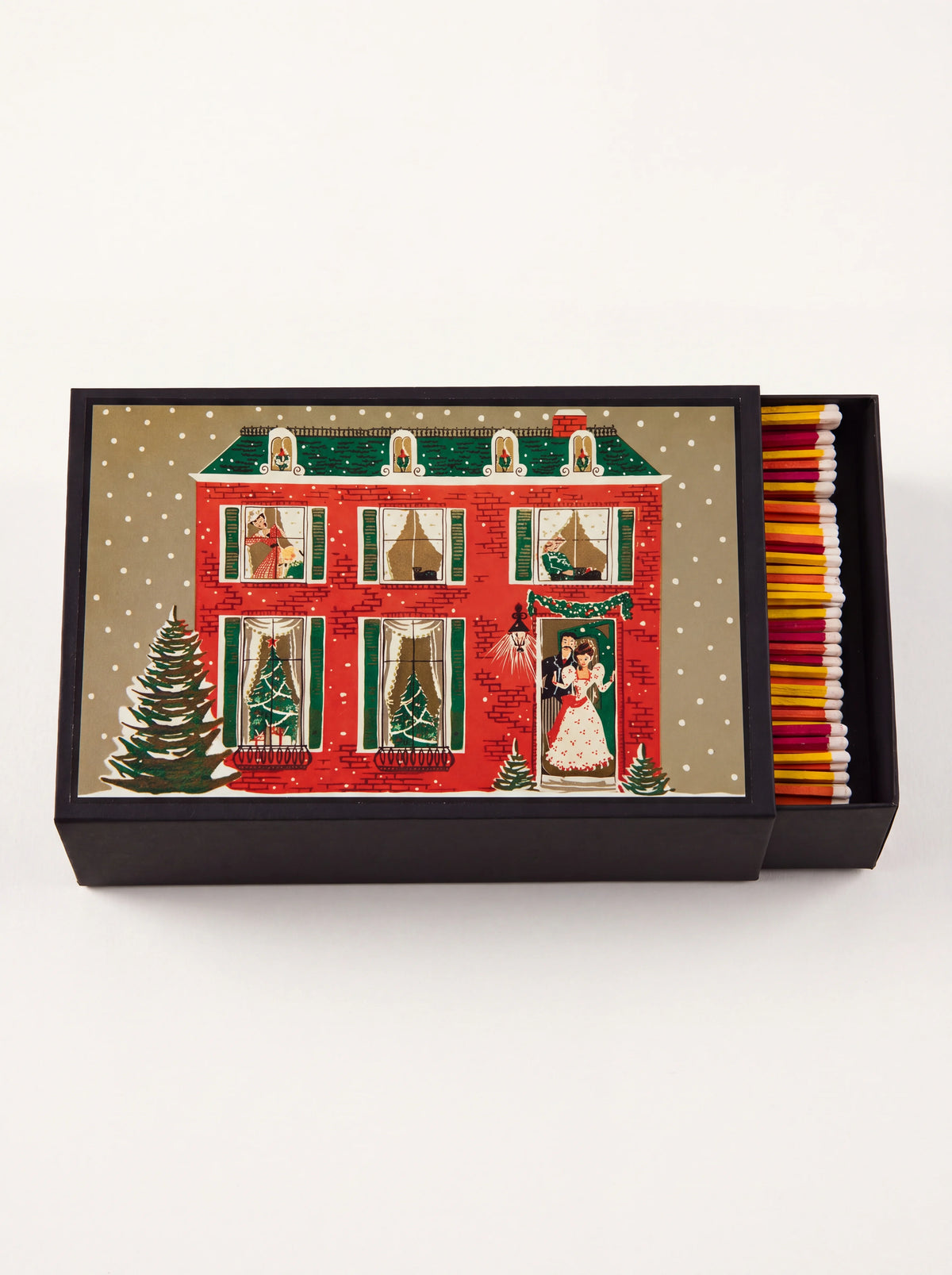 Giant matchbox with an illustrated festive townhouse cover, slid open to reveal colourful matches