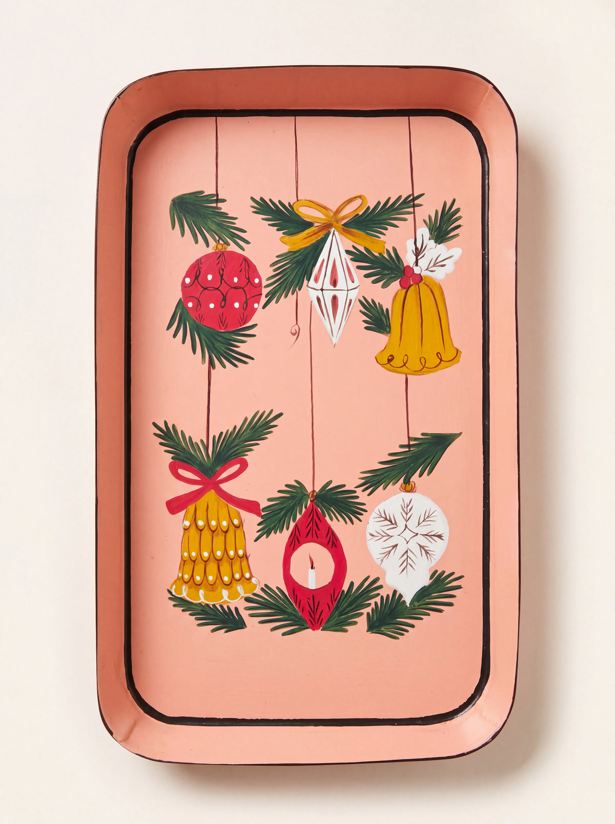 Rectangular pink iron tray painted with hanging Christmas ornaments and pine sprigs inside a dark border