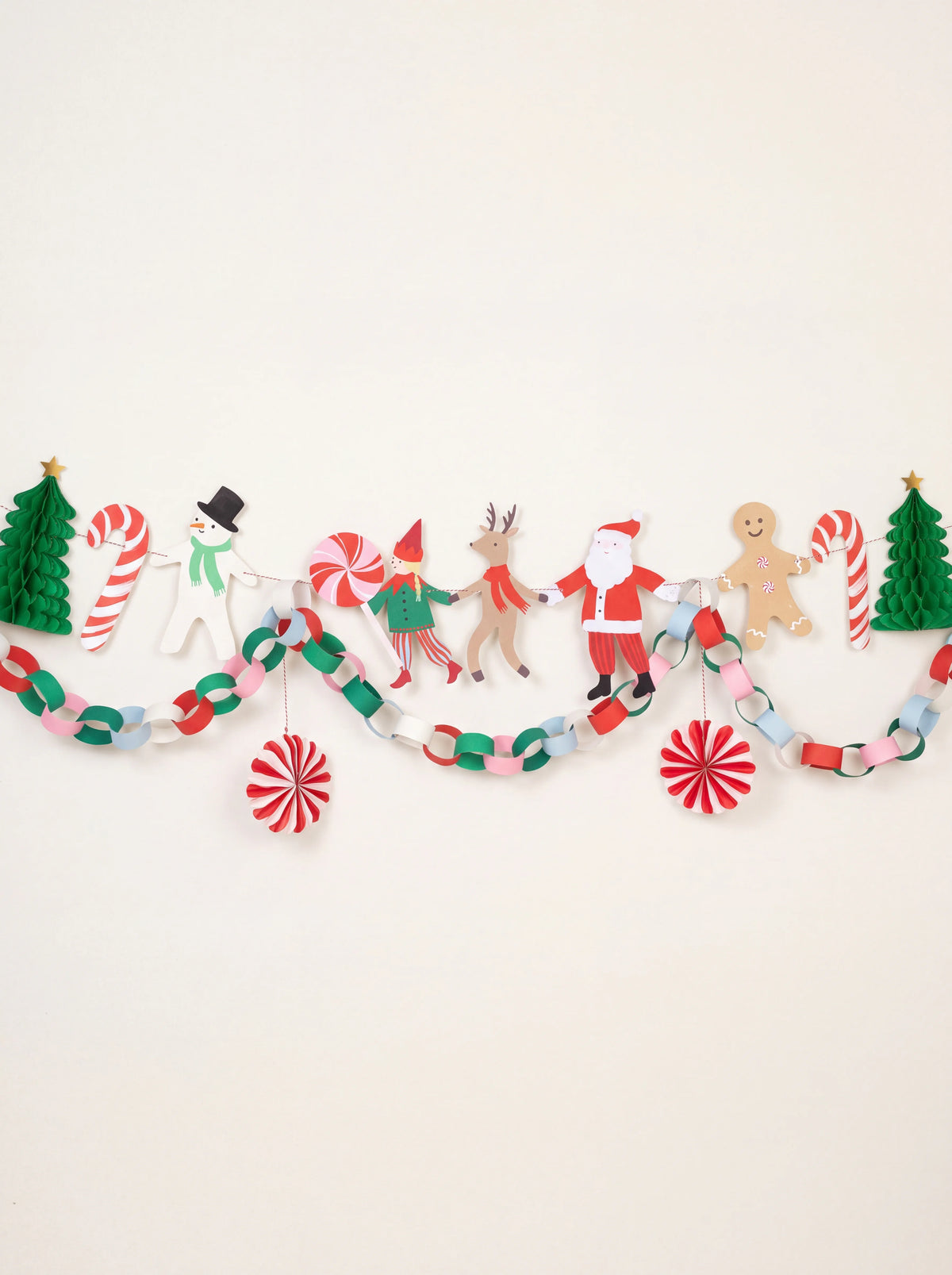 Christmas paper garland with festive character cut-outs, green honeycomb trees, a paper chain and pinwheels