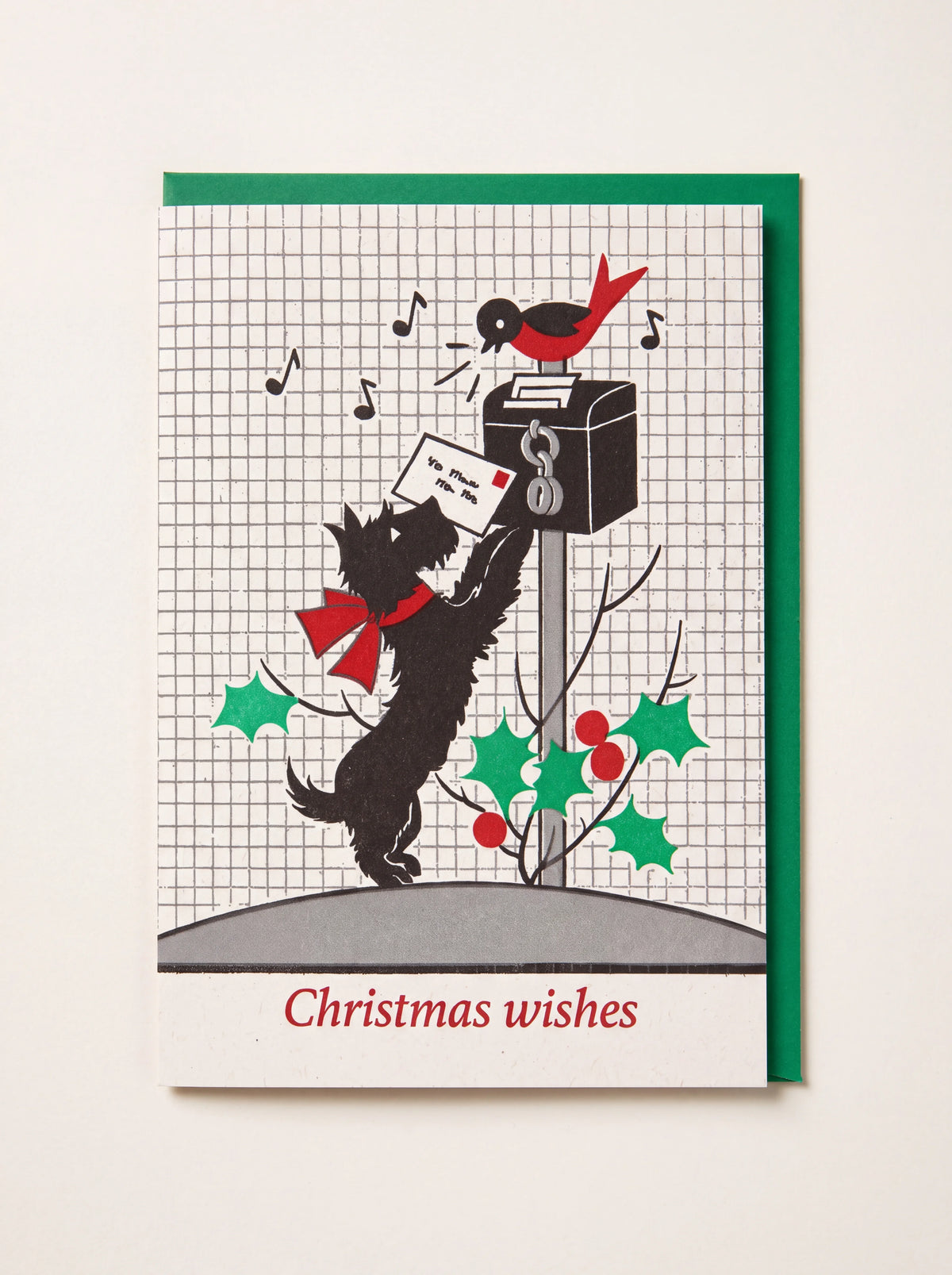 Christmas card illustrated with a dog posting a letter, a singing robin, and text reading Christmas wishes