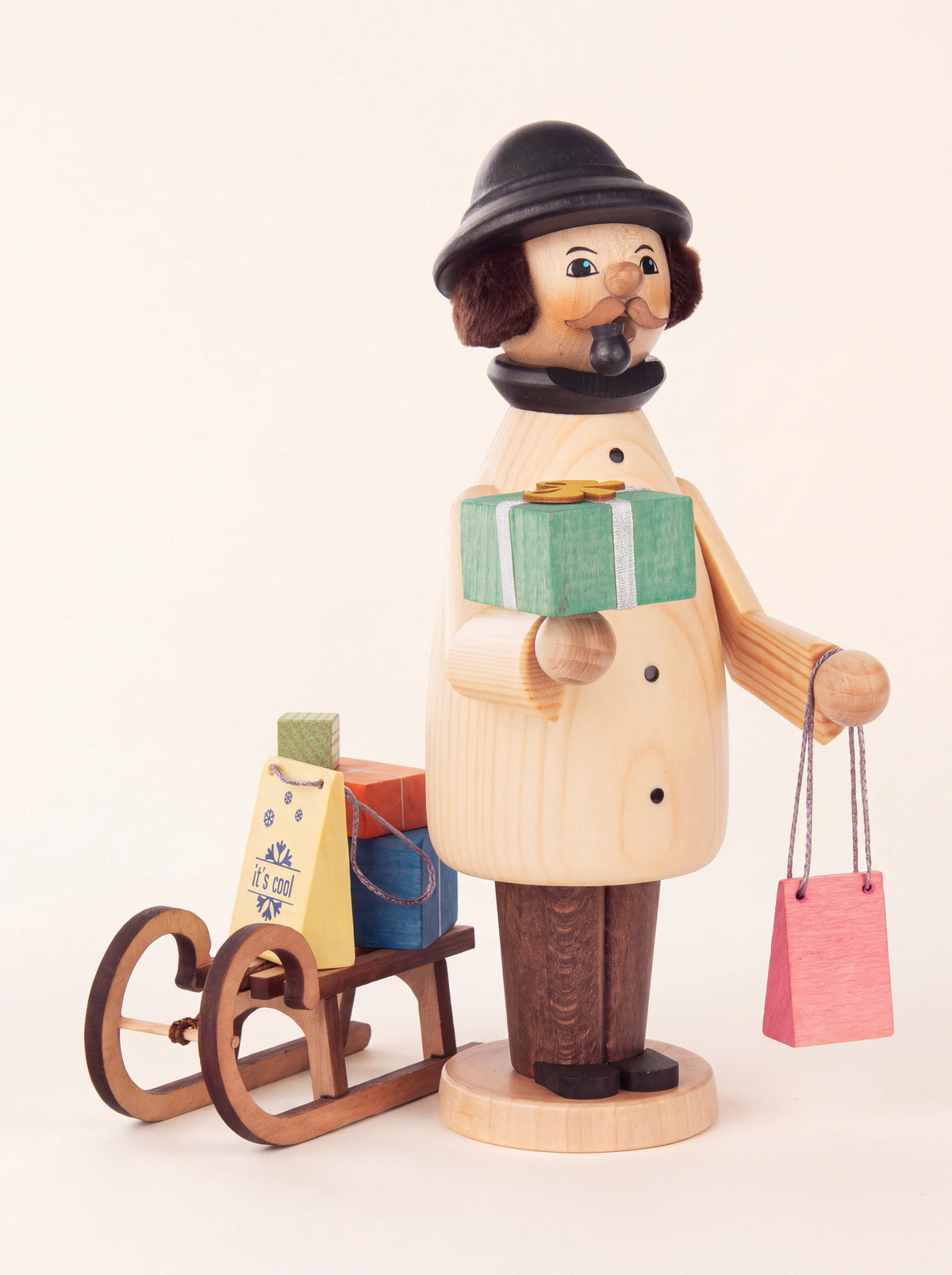 Wooden incense smoker shaped like a shopper with a pipe, holding gifts alongside a loaded sledge