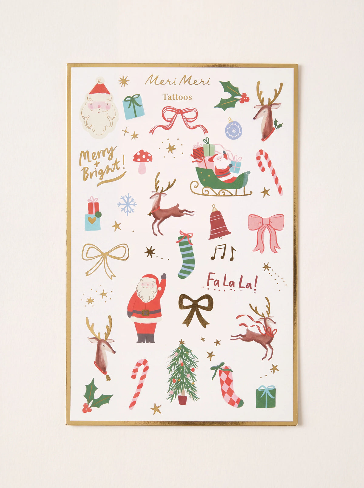 Christmas temporary tattoo sheet with Santa Claus, reindeer, Christmas tree, stockings, and gold foil accents