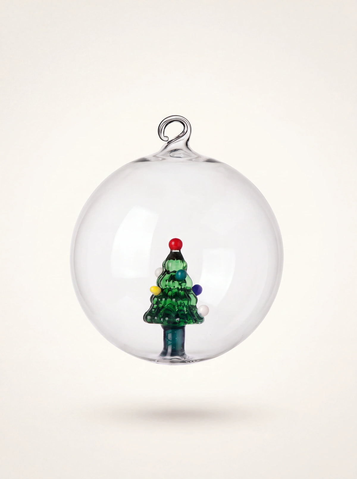 Clear glass bauble with an internal green Christmas tree figurine and a top hanging loop