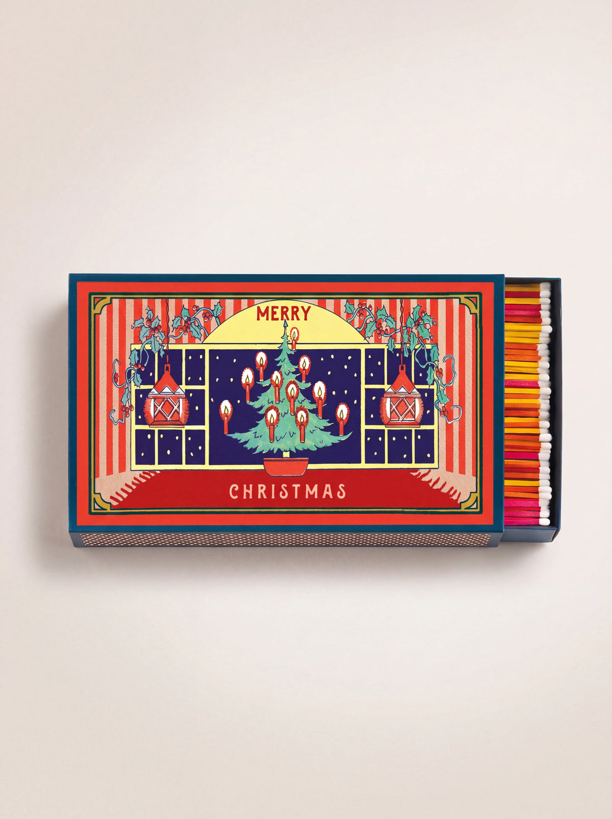 Large matchbox with a festive window scene reading Merry Christmas, partly slid open showing colourful matchsticks
