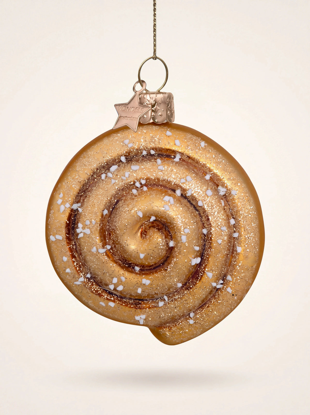 Glass cinnamon roll ornament with a brown spiral, glitter accents and white sugar sprinkles