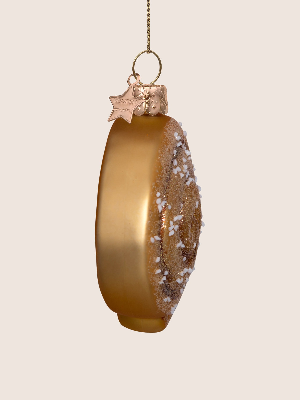 Side profile of the cinnamon roll ornament showing its depth and smooth matte brown glass edge