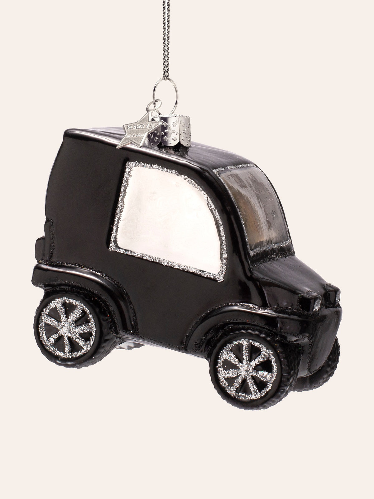 Right side view of the city car ornament showing the silver-edged window and textured tyres with glitter spokes