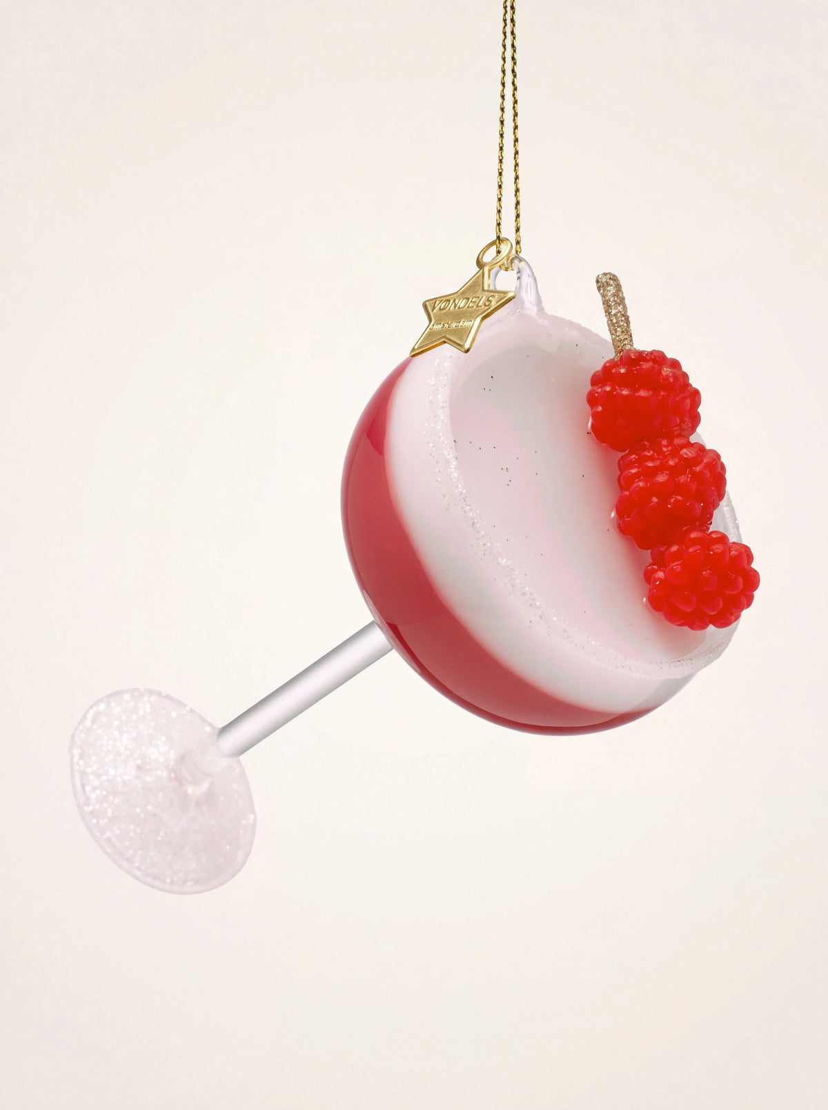 Glass Christmas ornament shaped like a Clover Club cocktail with pink liquid, white foam and raspberries