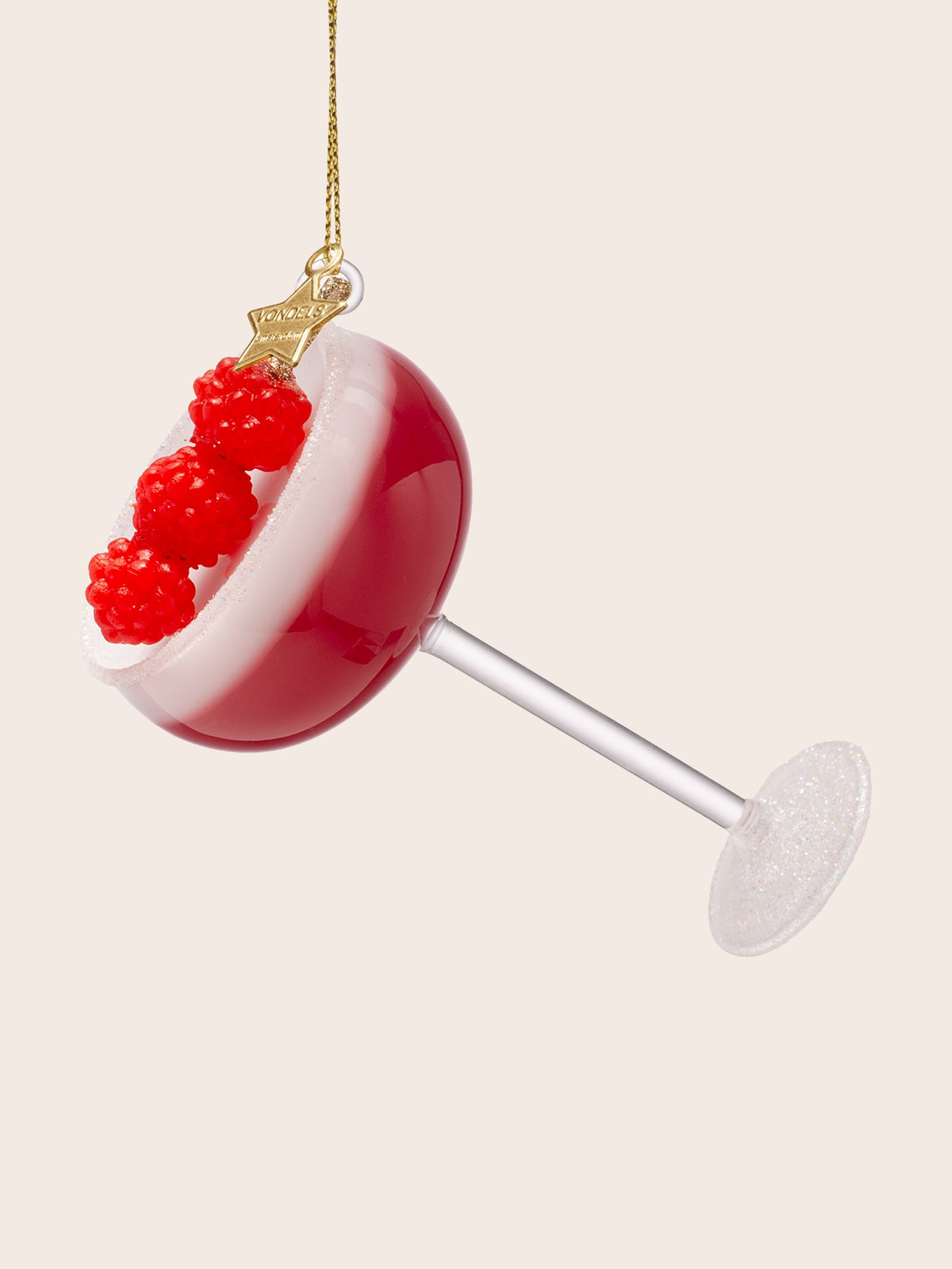 Side view showing the clear stem, glittered base and the curved pink bowl of the cocktail glass