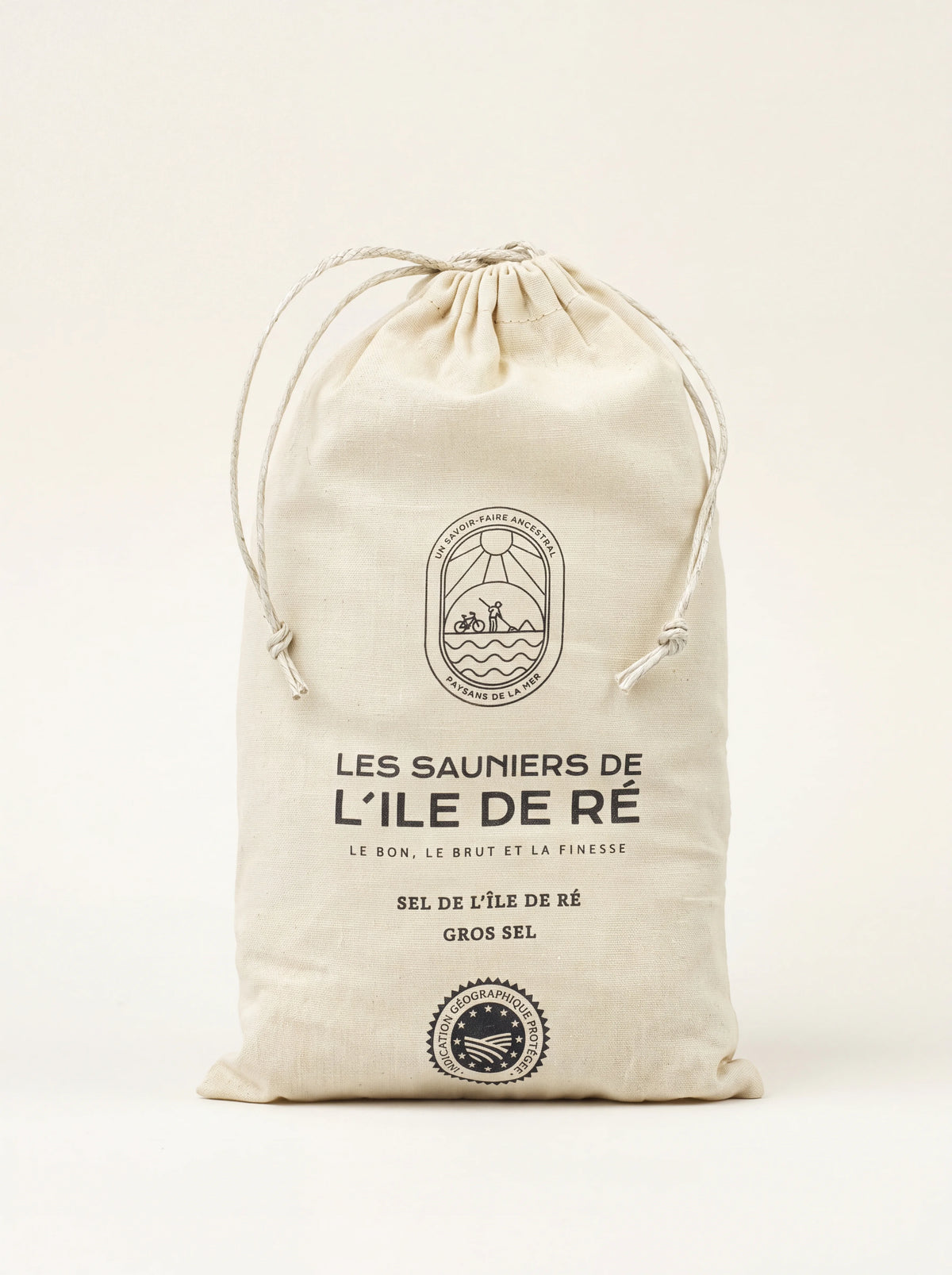 Coarse sea salt in an off-white cloth drawstring bag printed with Les Sauniers de L'Île de Ré Gros Sel