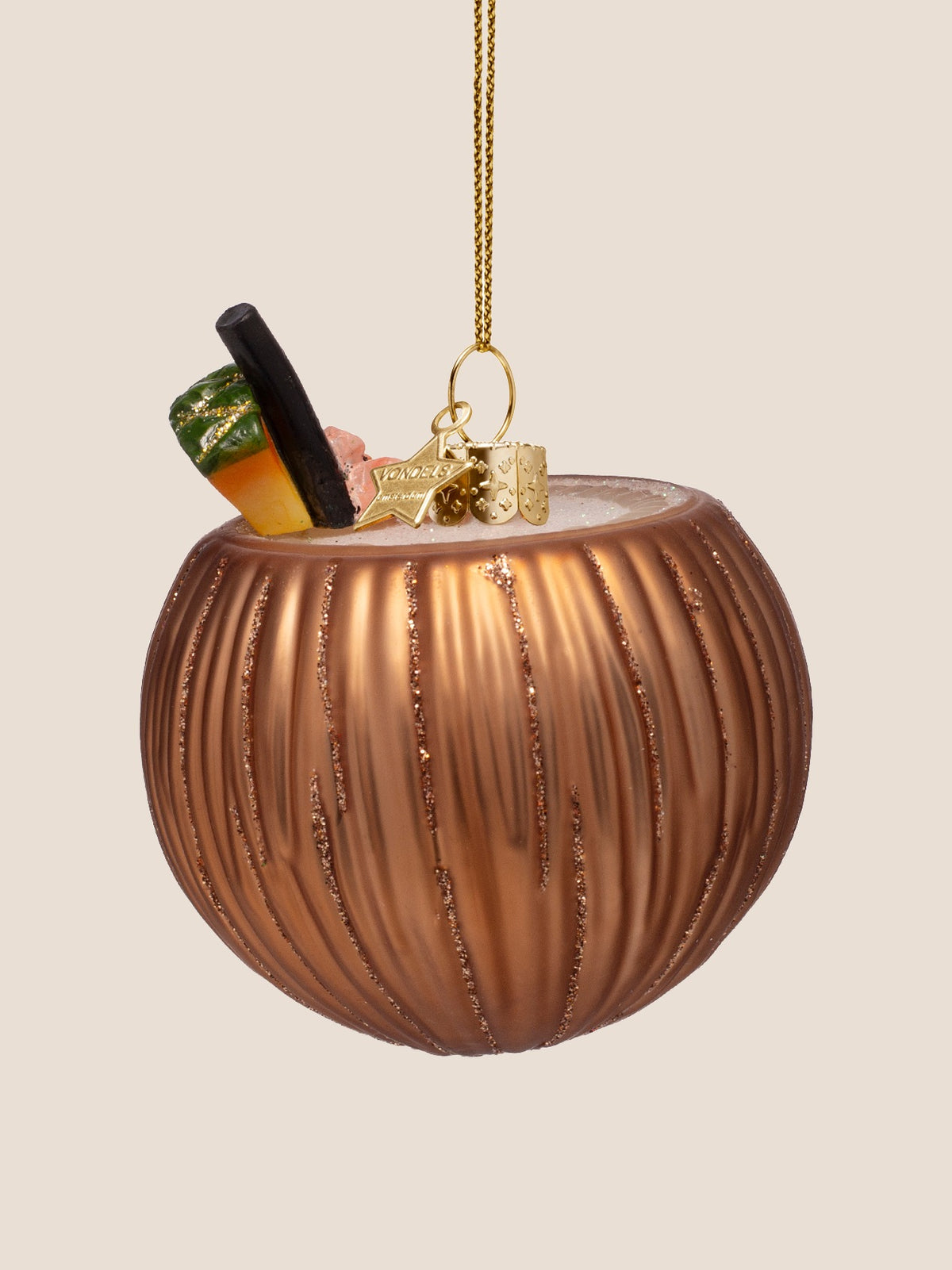 Coconut cocktail ornament rotated to show the white cocktail filling and gold hanging cap
