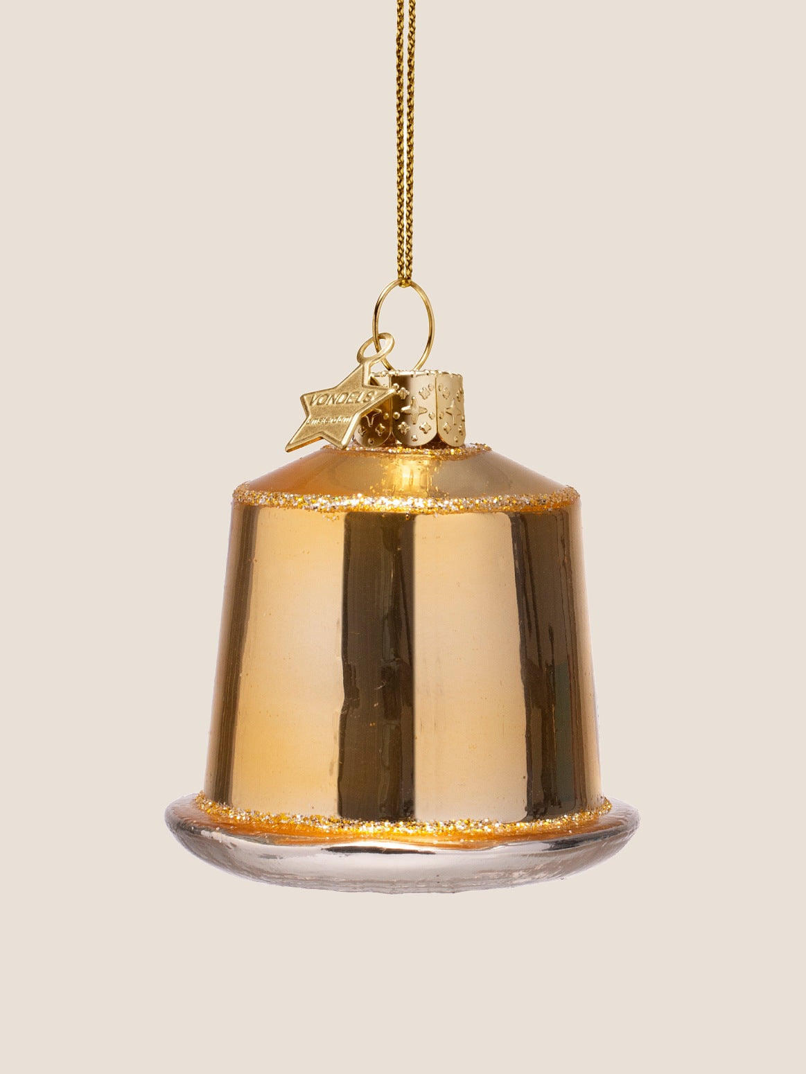 Back of the glass coffee capsule ornament showing the plain reflective gold body with glitter trim