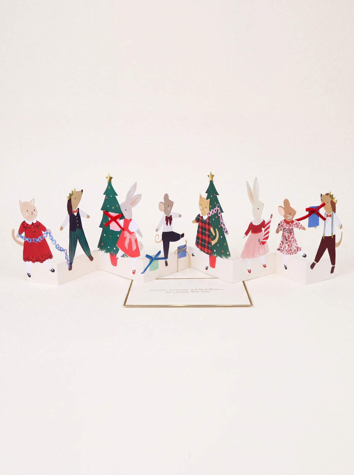 Concertina Christmas card standing open with illustrated dressed animals, Christmas trees and an insert card
