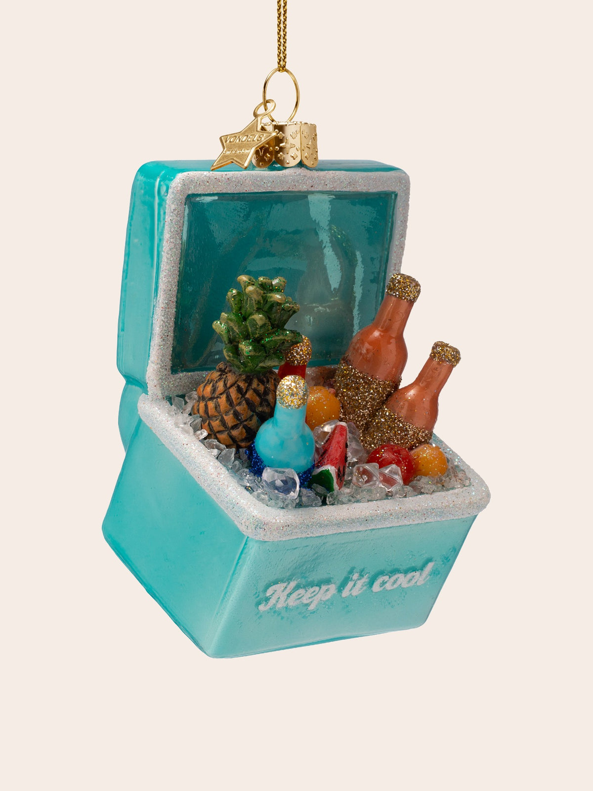 Cool box ornament angled to show glitter-dusted bottles and tropical fruit resting in faux ice