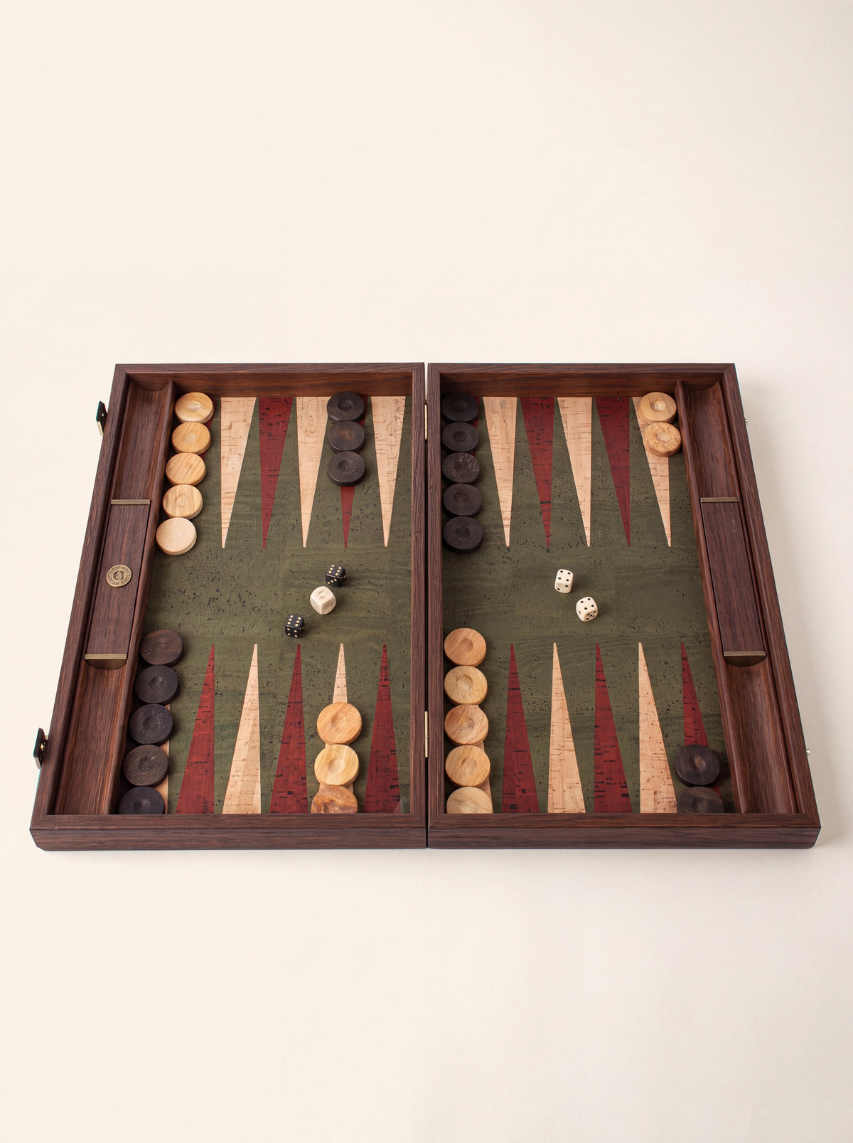 Wooden backgammon set open with green cork surface, red and natural inlaid points, checkers and dice