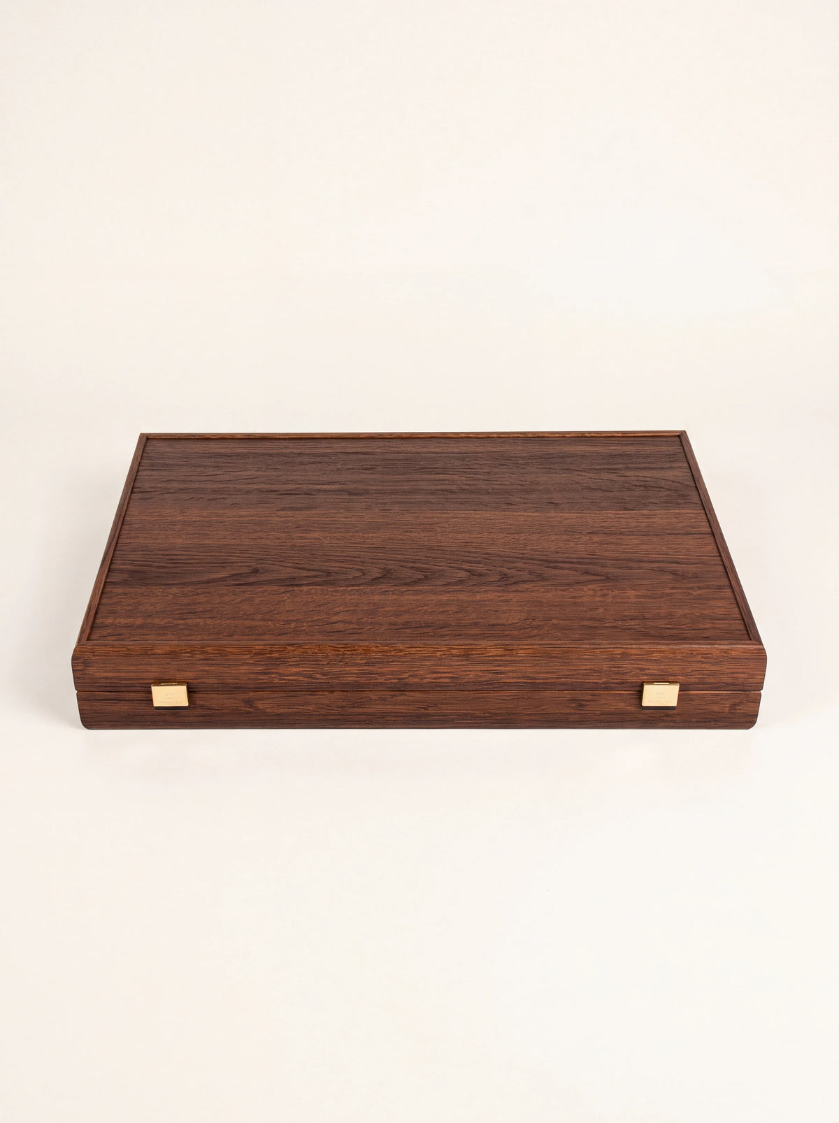 Closed wooden backgammon case showing the dark wood grain exterior and two metal clasps