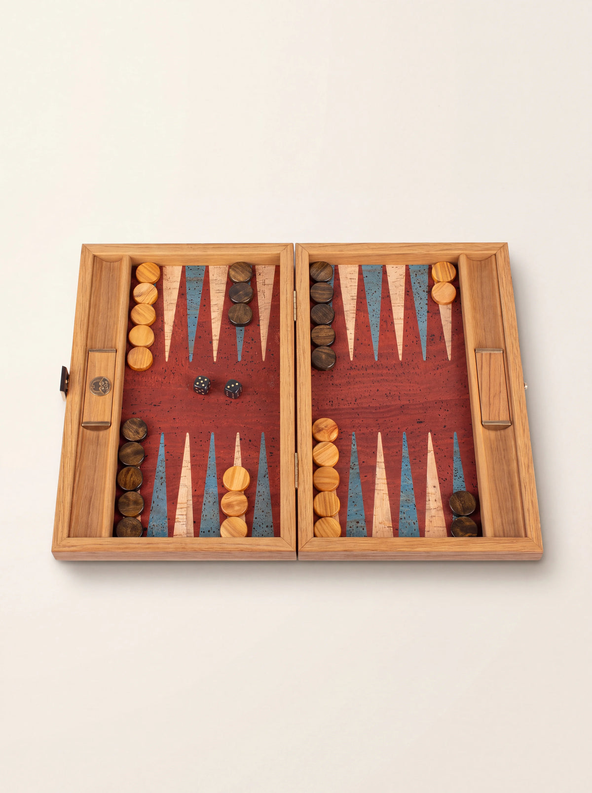 Open wooden backgammon set with red cork playing field, turquoise and natural points, checkers and dice