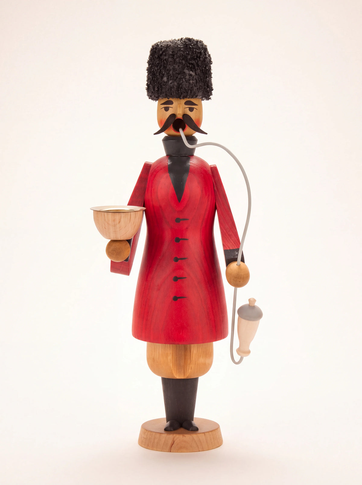 Cossack wooden incense smoker in a red coat with a tall black textured hat, holding a bowl and pipe