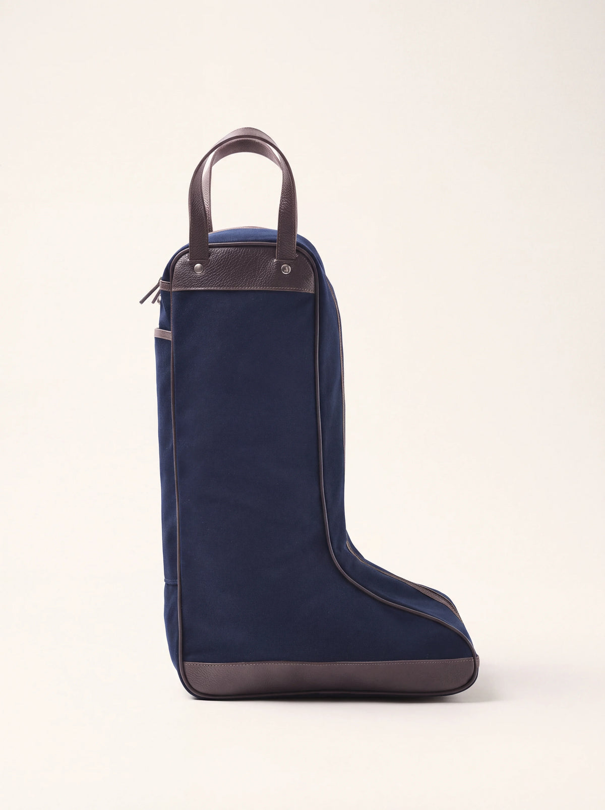 Navy cotton canvas boot bag with brown leather handles and trim, shaped for tall boots