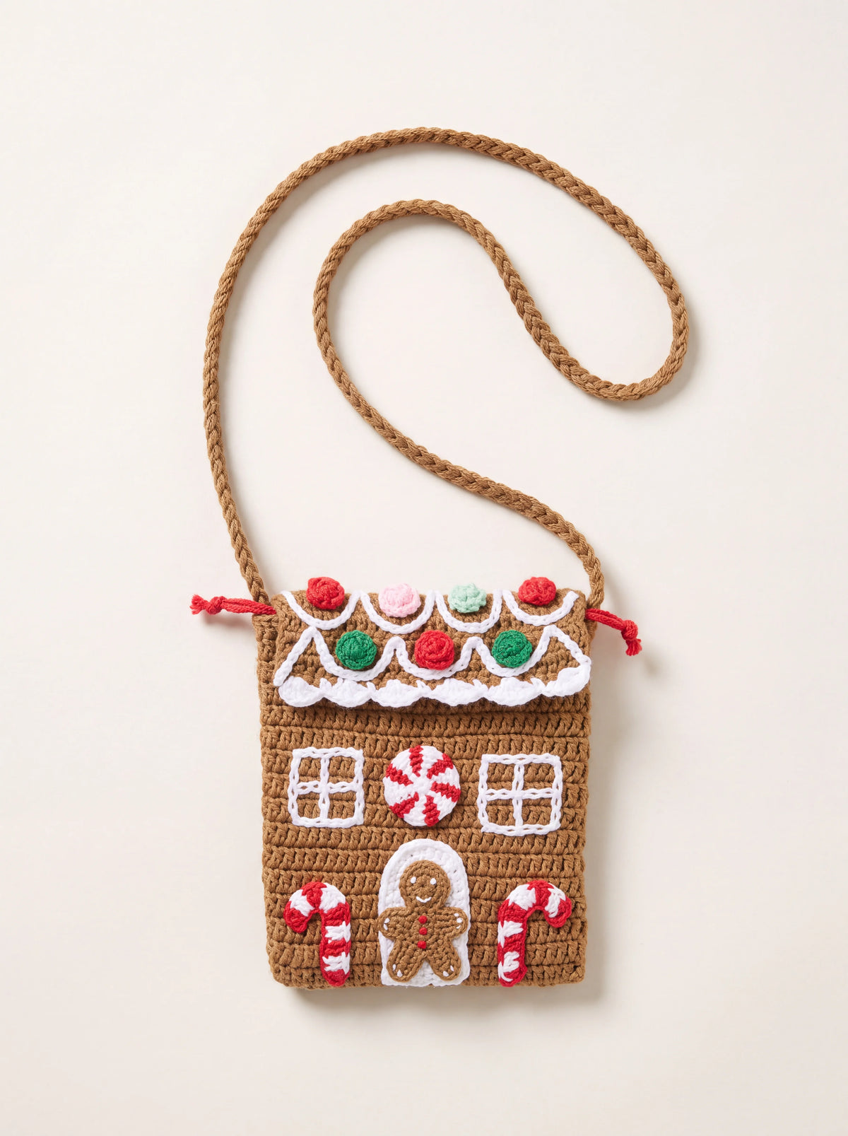 Crochet cotton bag shaped as a gingerbread house with candy motifs, window details, and a plaited shoulder strap
