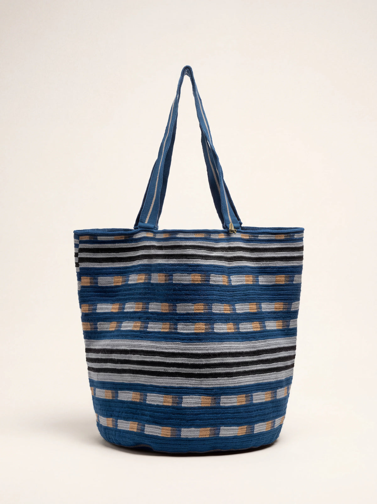 Crocheted tote bag with geometric stripes in blue, grey, black and toast, featuring two long handles