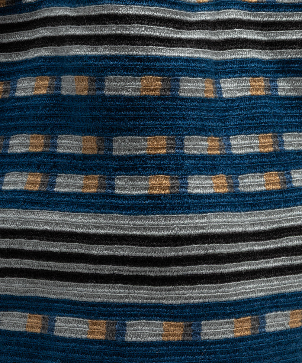 Close-up of the crocheted acrylic fabric showing the striped texture in blue, grey, black and toast