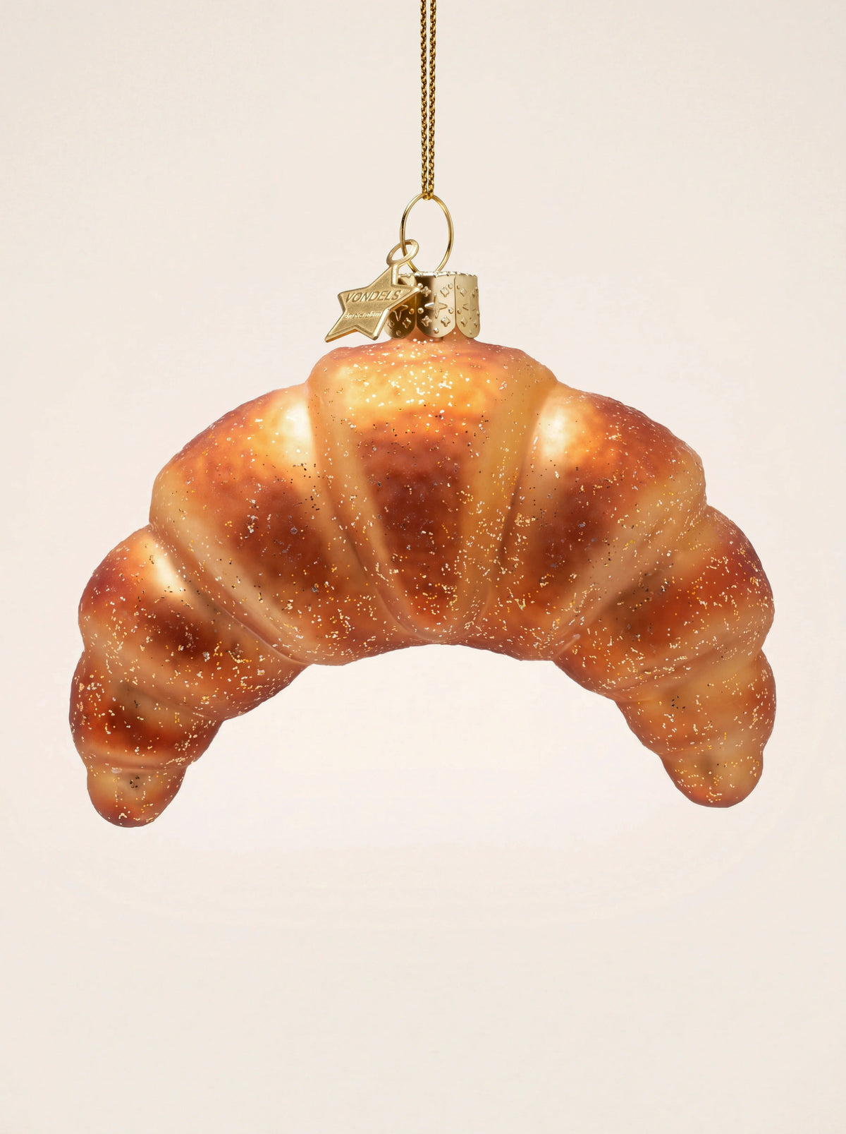 Glass croissant Christmas ornament with golden-brown finish, fine glitter and a gold hanging loop