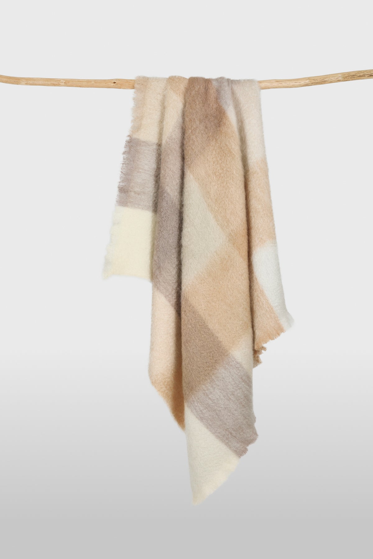 Mohair throw in a cream, beige, and taupe check pattern with brushed texture and fringed edges