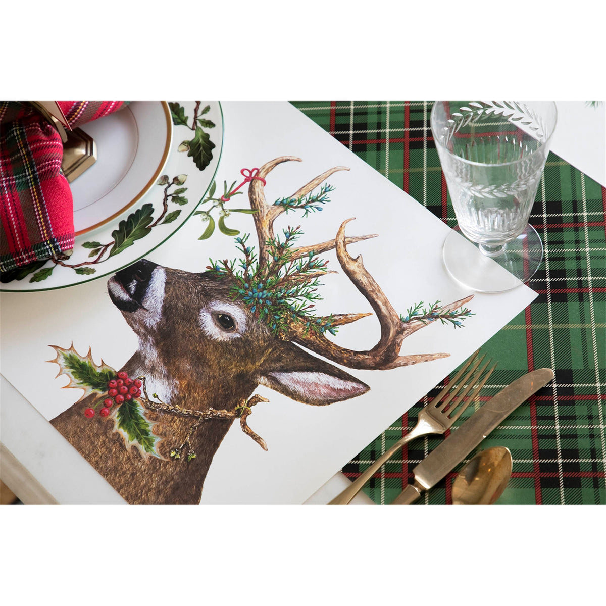 Paper placemat laid on a table setting with cutlery, a glass and a dinner plate on green tartan