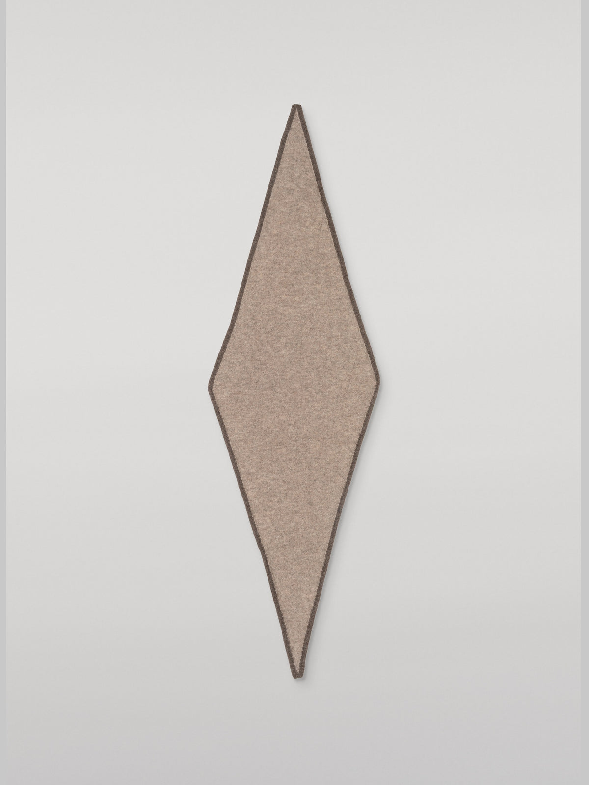 Cashmere necktie laid flat, showing the elongated diamond shape with dark brown contrast edging