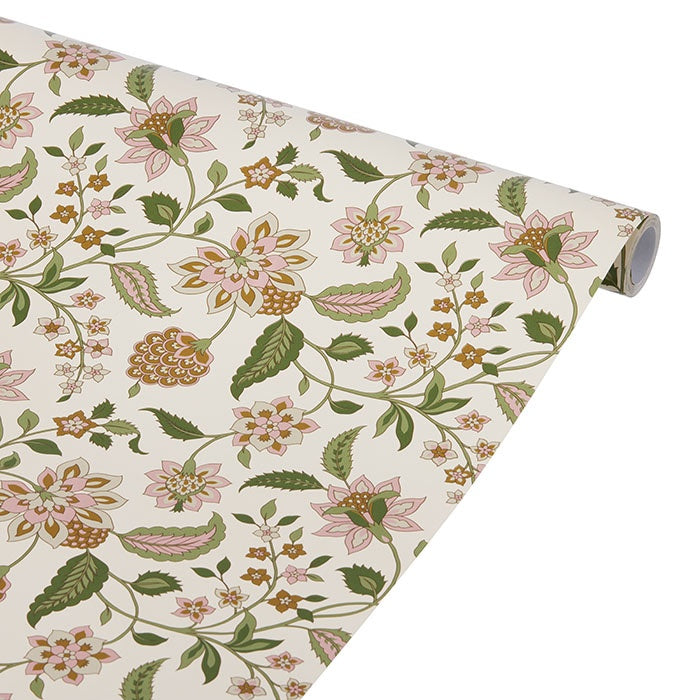 Semi-matte wrapping paper unrolled to show a botanical floral pattern in moss green, pink and ochre on cream