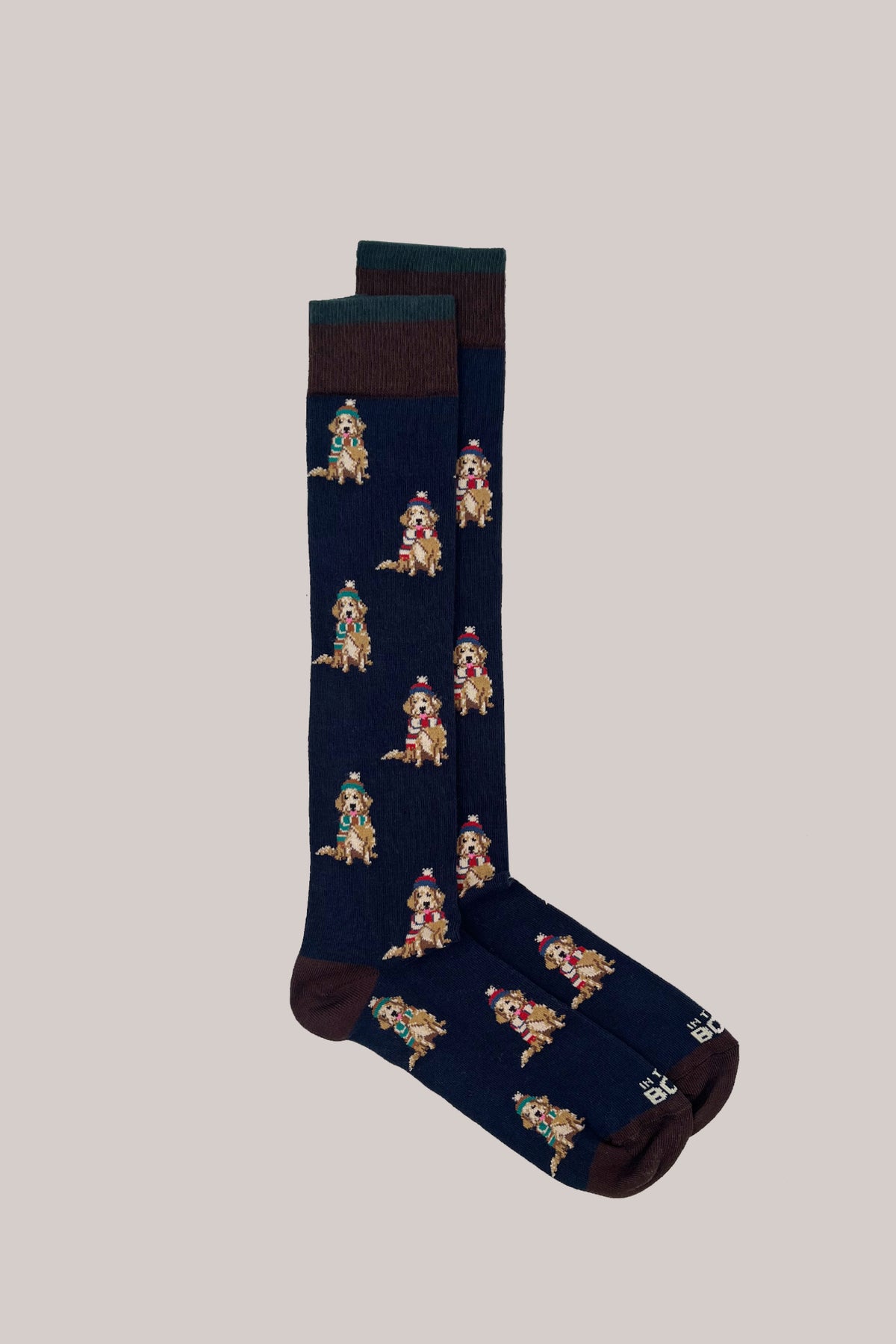 Dark blue calf-length cotton socks with ribbed cuffs and a knitted pattern of dogs wearing hats and scarves