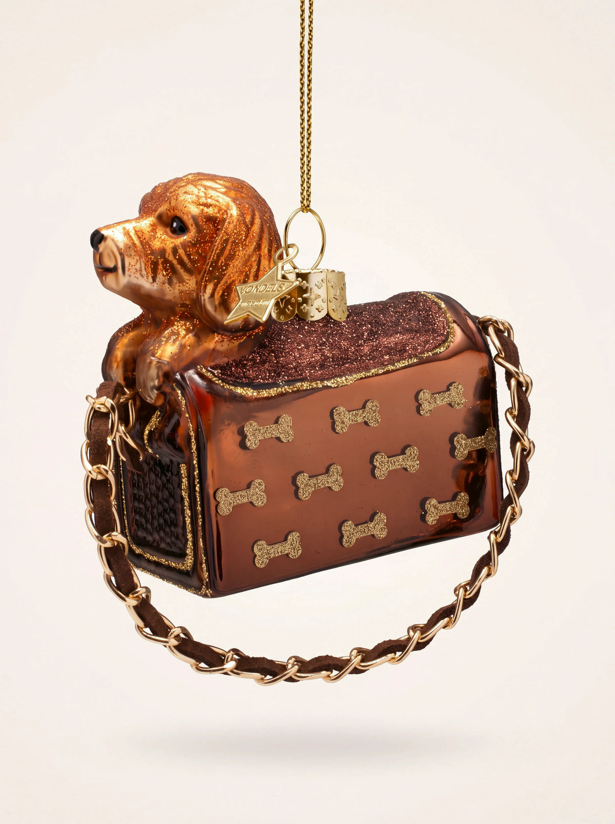 Mouth-blown glass dog in bag ornament decorated with glitter bones and a chain strap