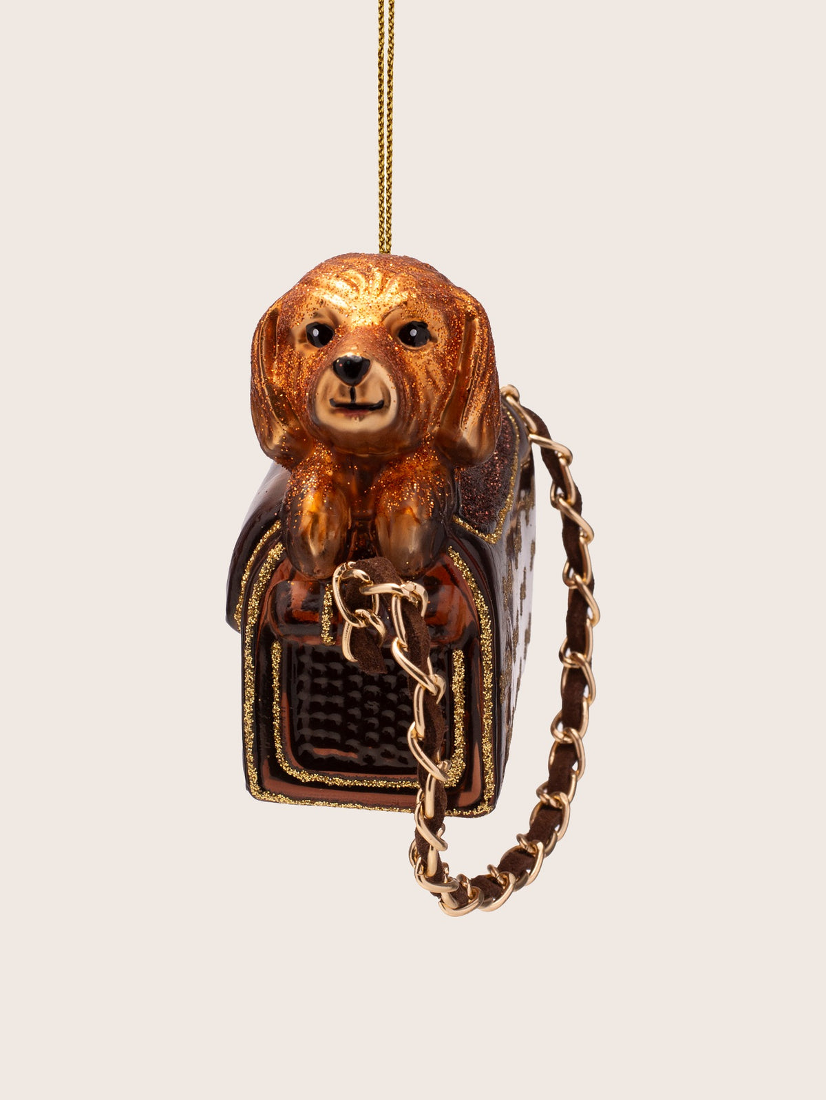 Front view of the dog in bag ornament showing the dog facing forward over the mesh opening
