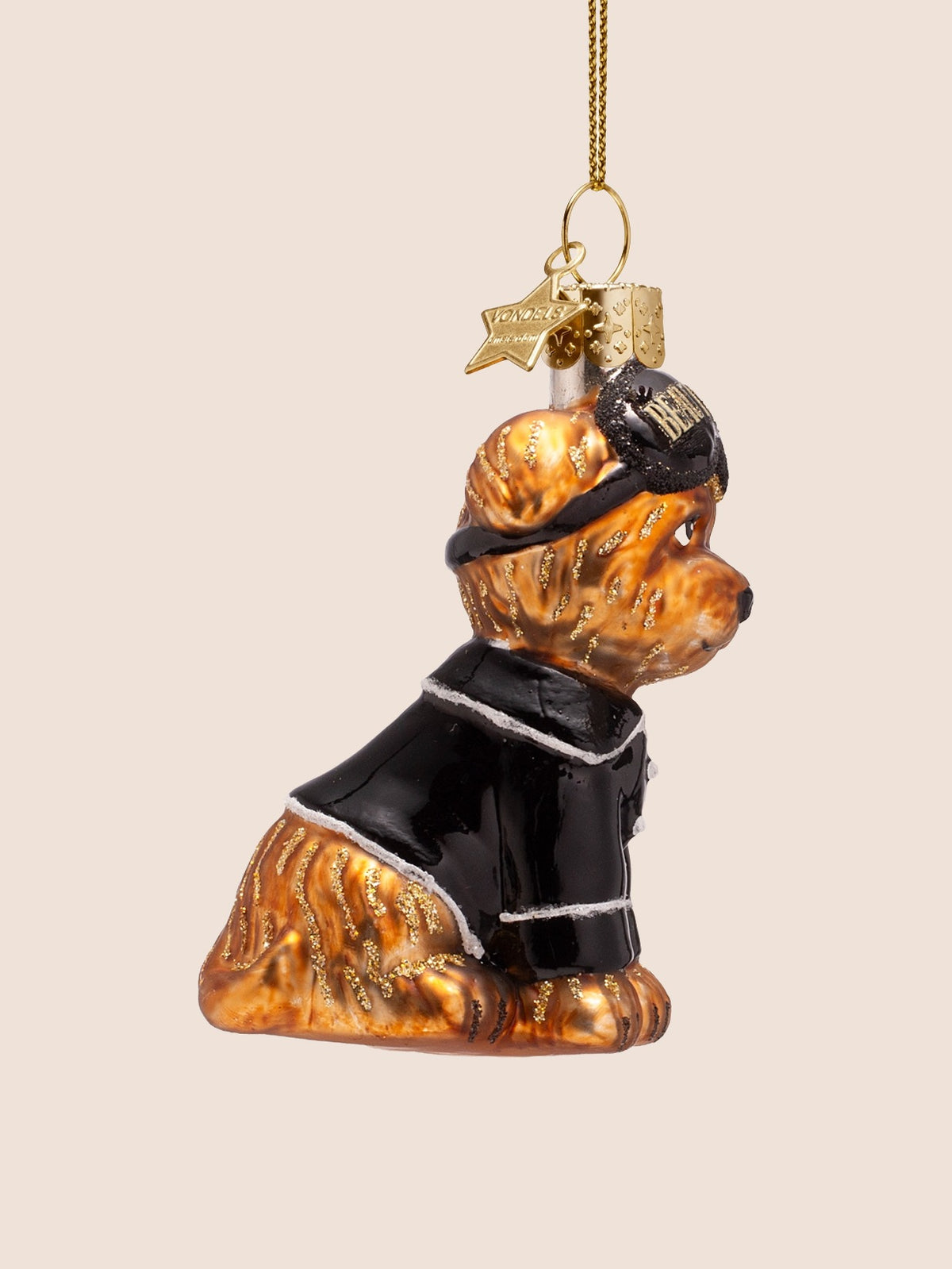 Side profile of the seated glass dog ornament showing glitter markings along the back