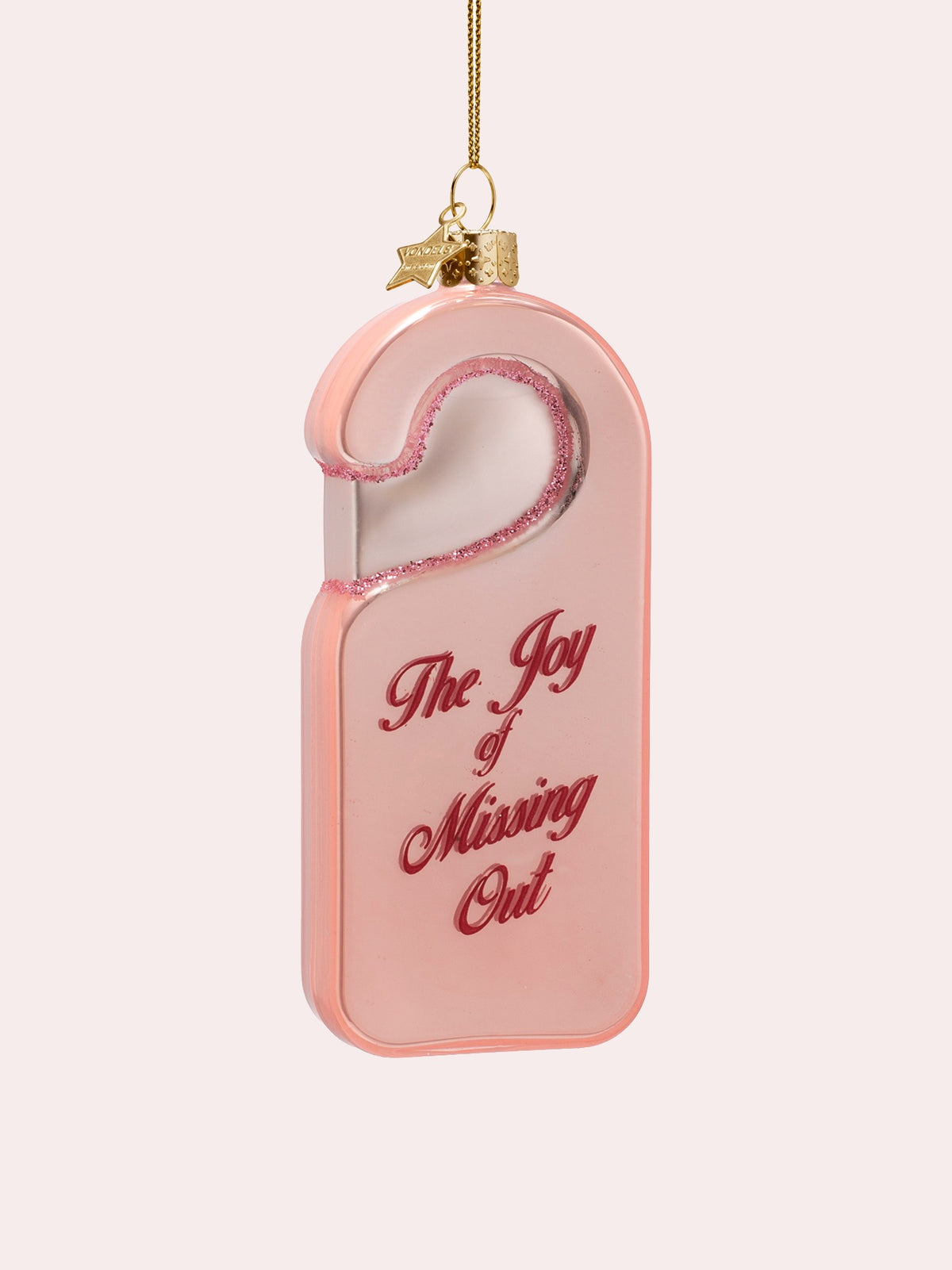 Three-quarter view showing the glossy finish and gold hanging cap with a star charm